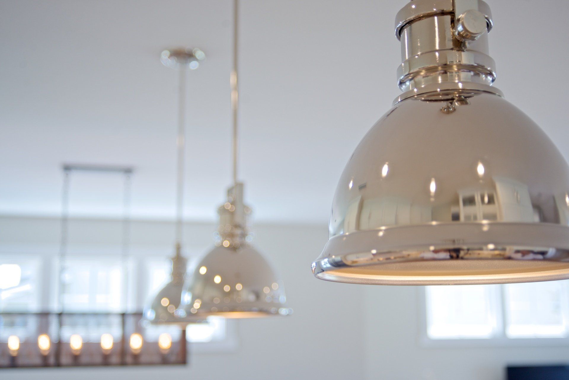 Three pendant lights are hanging from the ceiling in a room.