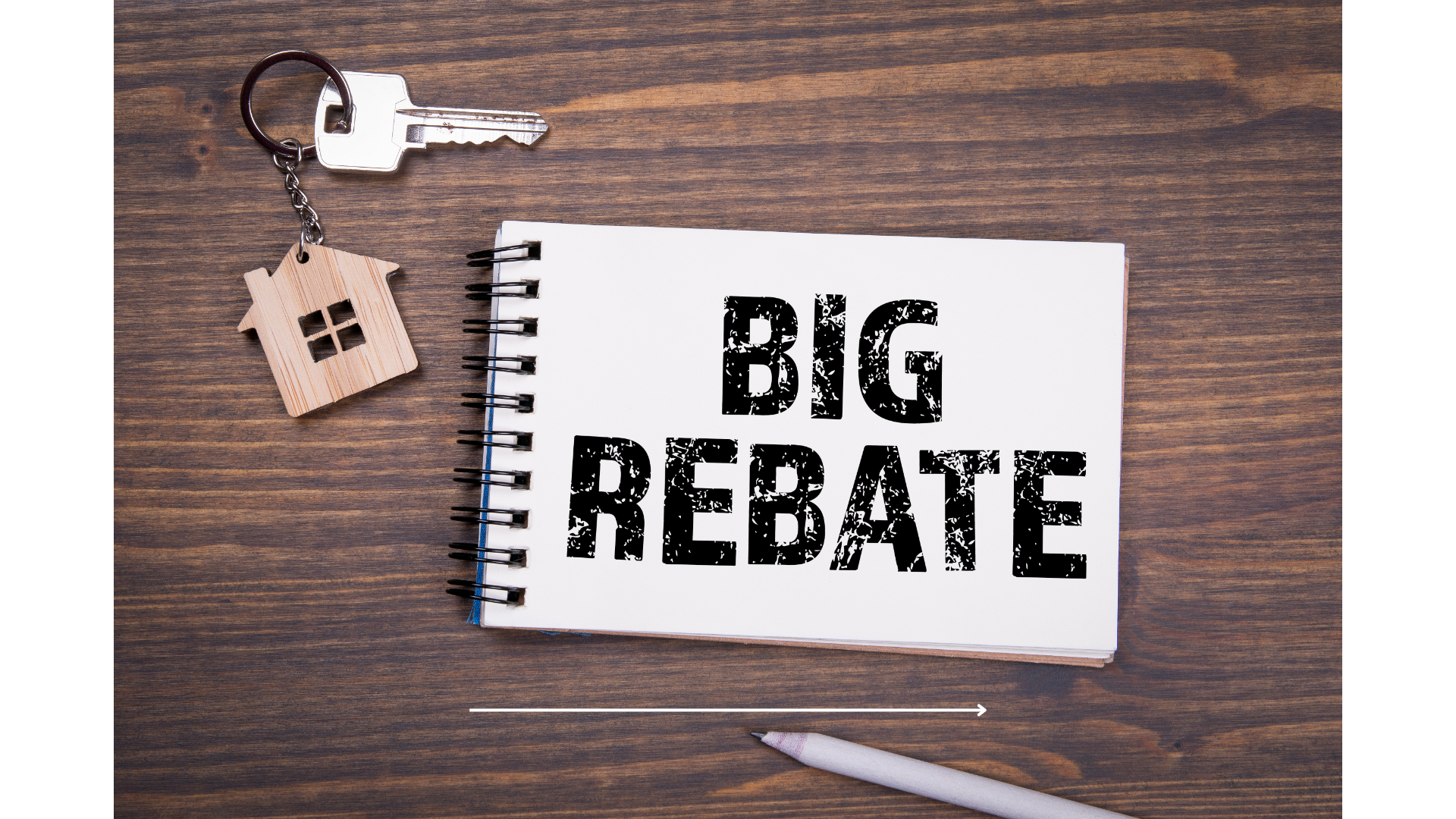 A notebook with the words `` big rebate '' written on it is on a wooden table.