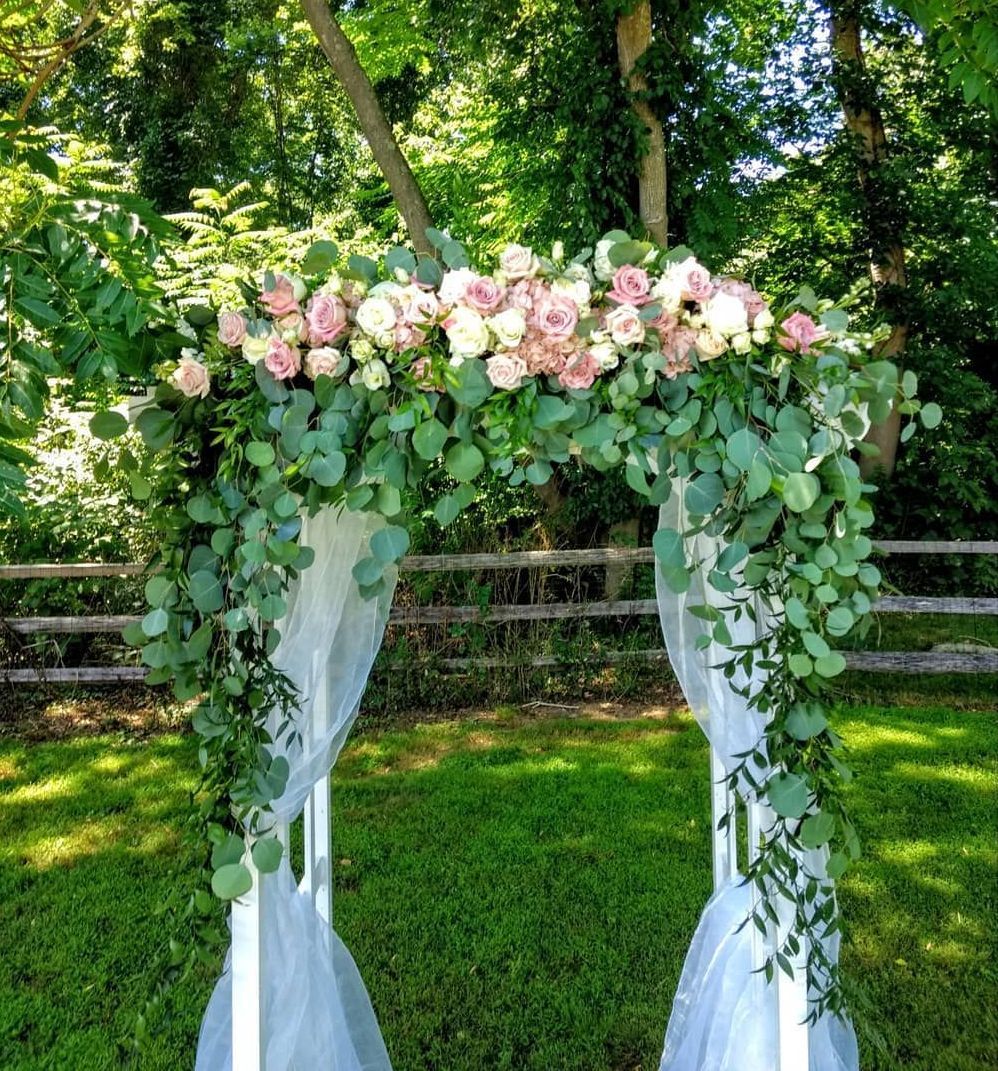 Tulips Floral Design located in Westbrook, CT creates beautiful wedding flower arches.