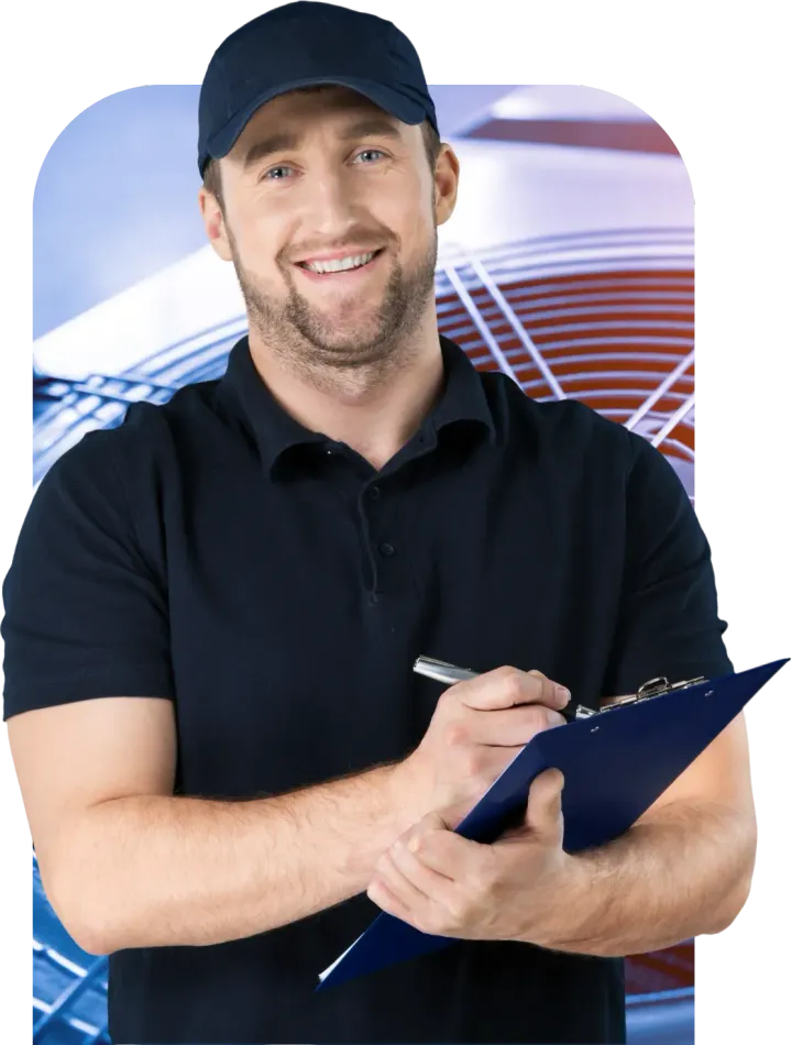 Man in a dark uniform smiling, holding a clipboard and pen, with blurred background of wiring.