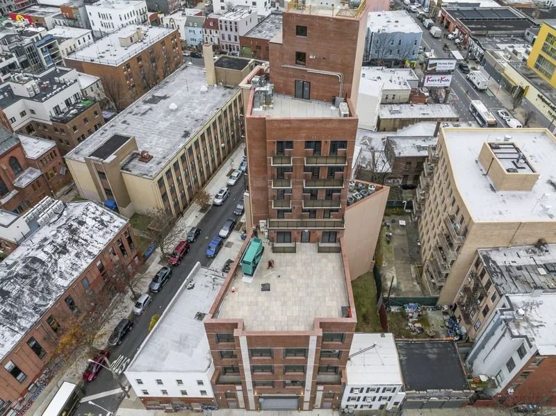 Aerial view of snow-covered city blocks with apartment buildings and narrow streets