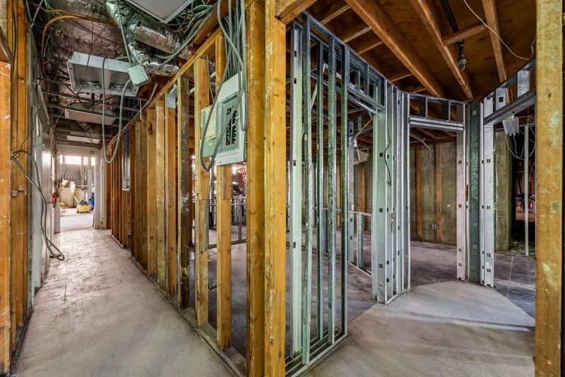 Interior of a house under construction with exposed wood framing and unfinished walls