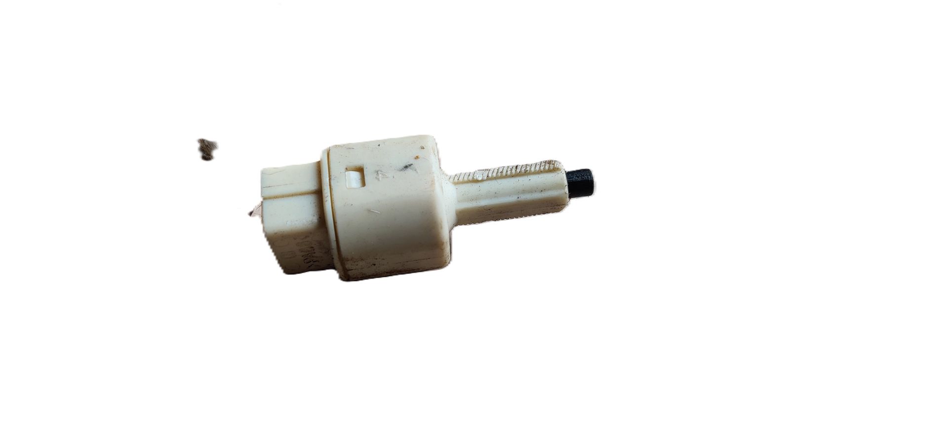 Een beige, cilindrische plastic ontstekingsknop voor een gastoestel, met een kleine zwarte drukknop aan één uiteinde.