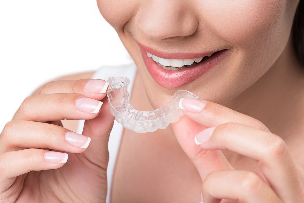 Smiling Woman Undergoing Clear Aligner Treatment — Aspire Dental in Townsville, QLD