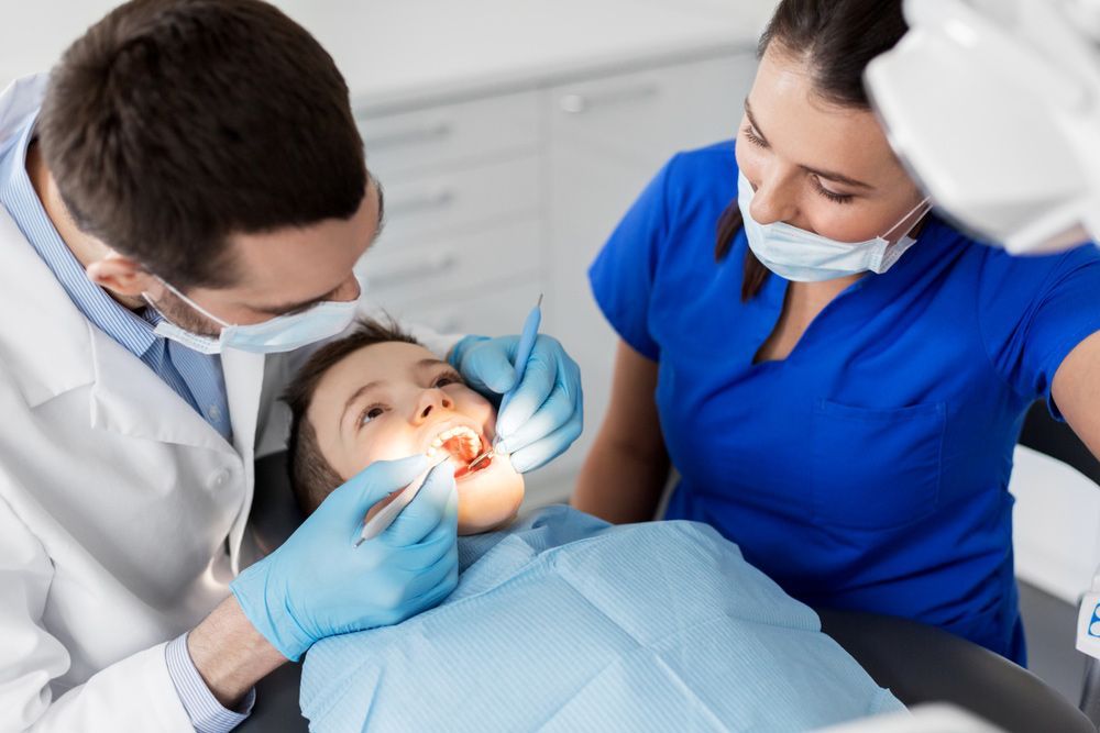 Dentist Checking Child's Teeth in A Dental Clinic