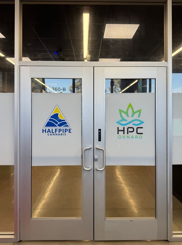 Glass double doors with frosted panels and HPC/Halere signs in a hallway entrance