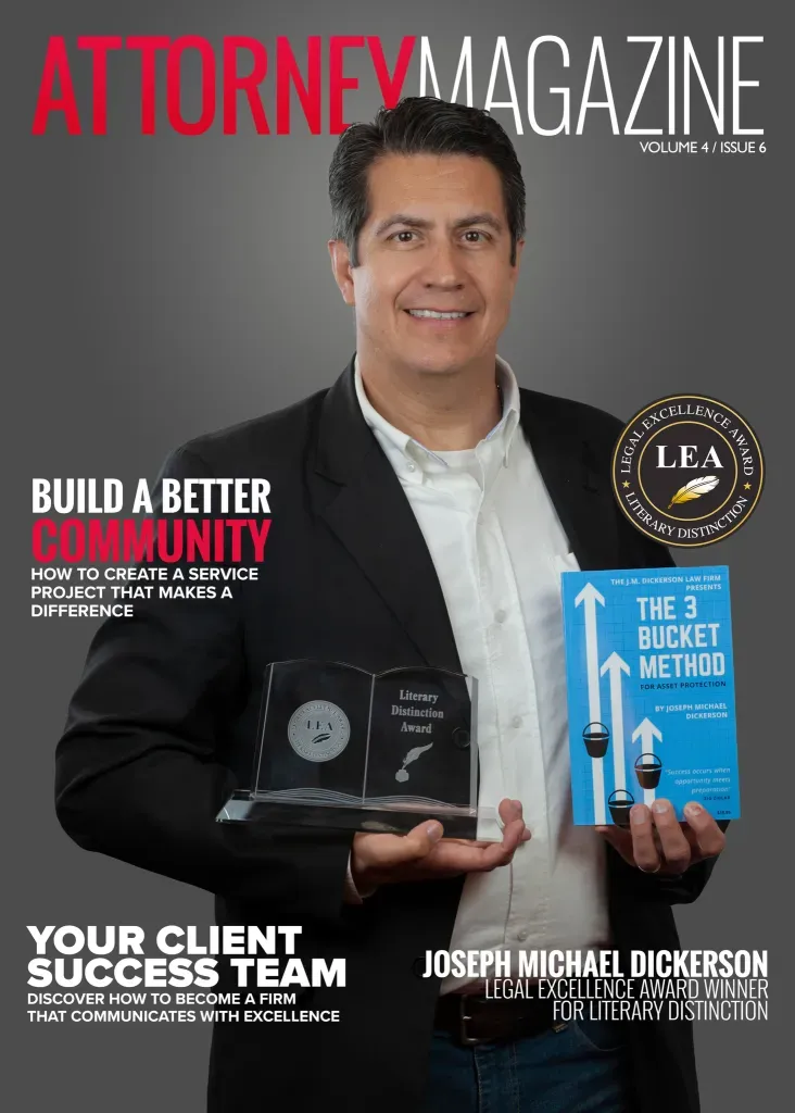 Man holding a magazine in black background | Laredo, TX | The J.M. Dickerson Law Firm PLLC