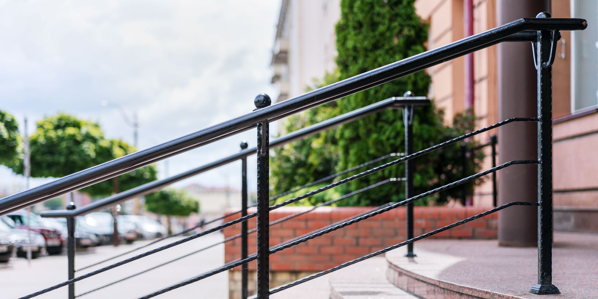 Black metal railing on a brick and concrete building exterior Black metal railing on a brick and concrete building exterior