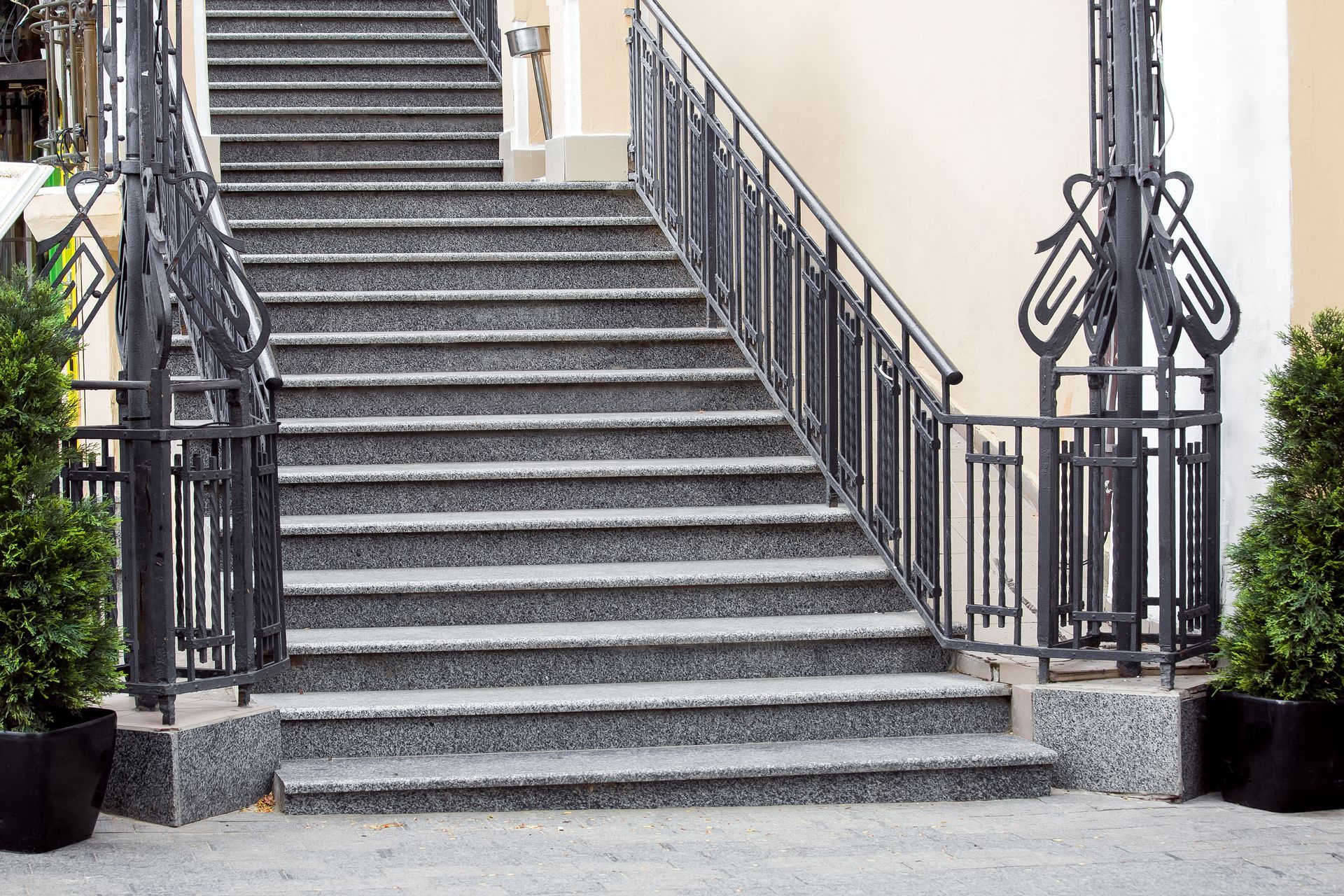 Granite staircase with black wrought-iron railings Granite staircase with black wrought-iron railings