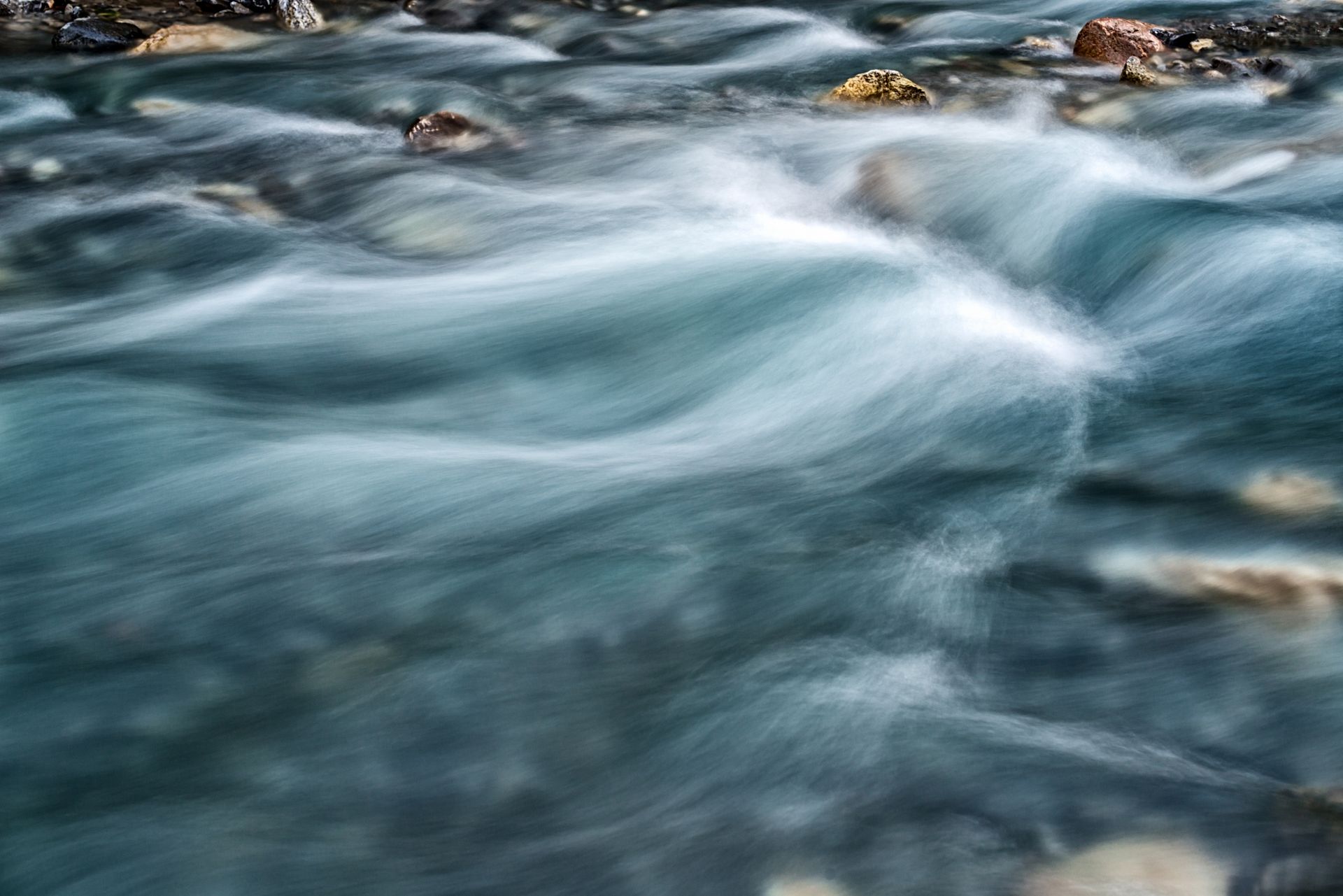 A close up of a river flowing through a rocky area. A close up of a river flowing through a rocky area.