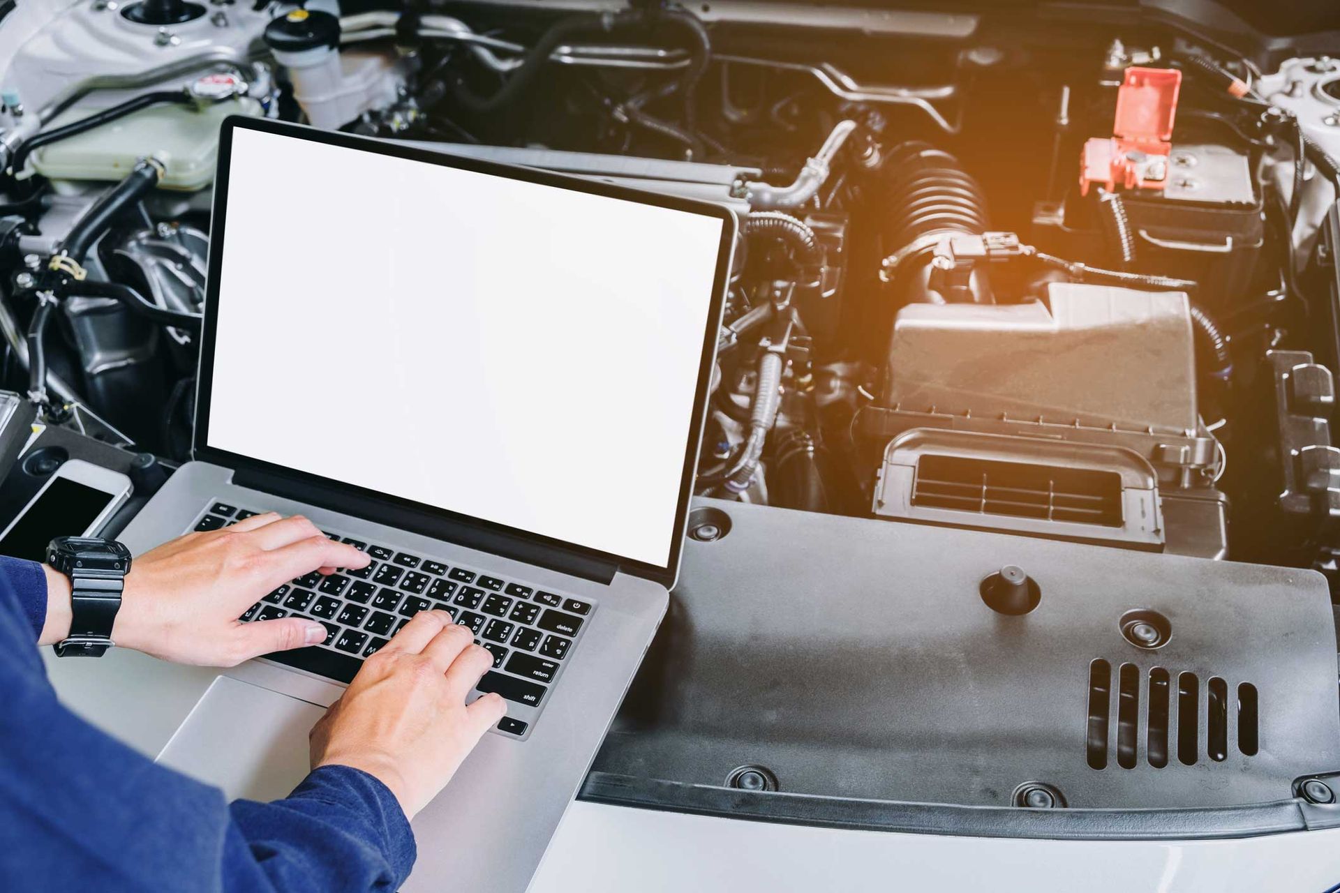 Professional Car Mechanic Working In Auto Repair Service Using Laptop On Car — Bloomington, IL — Bloomington Normal Truck Performance Professional Car Mechanic Working In Auto Repair Service Using Laptop On Car — Bloomington, IL — Bloomington Normal Truck Performance