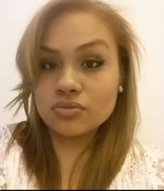 A close up of a woman 's face with a serious look on her face