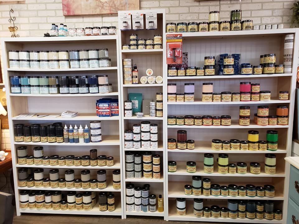 A store filled with lots of jars of paint and candles