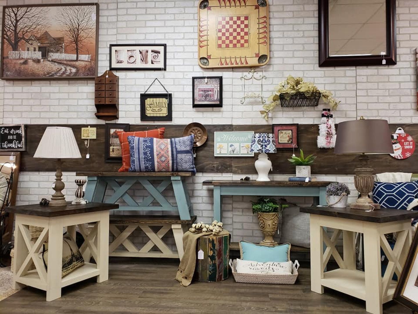 A living room filled with furniture and a brick wall.