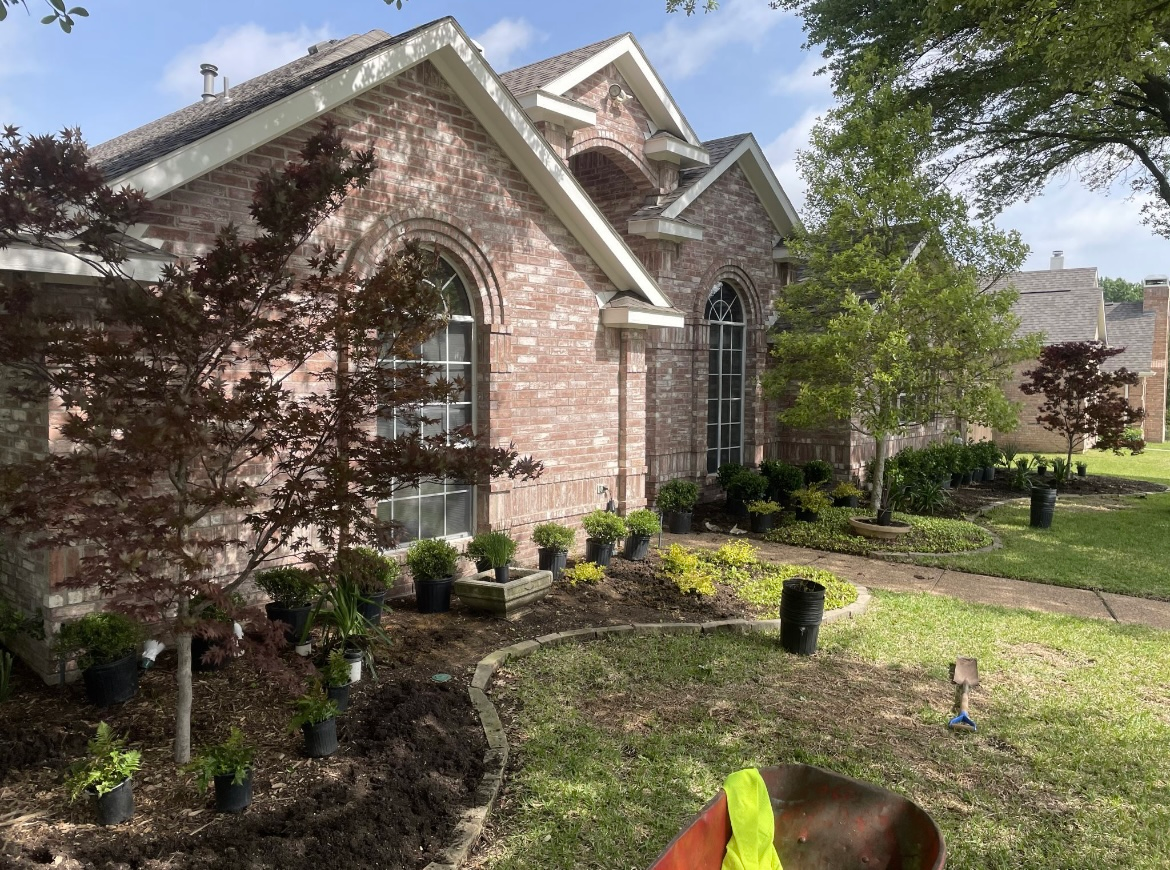 Stone house with arched front porch and curved walkway in a sunny yard