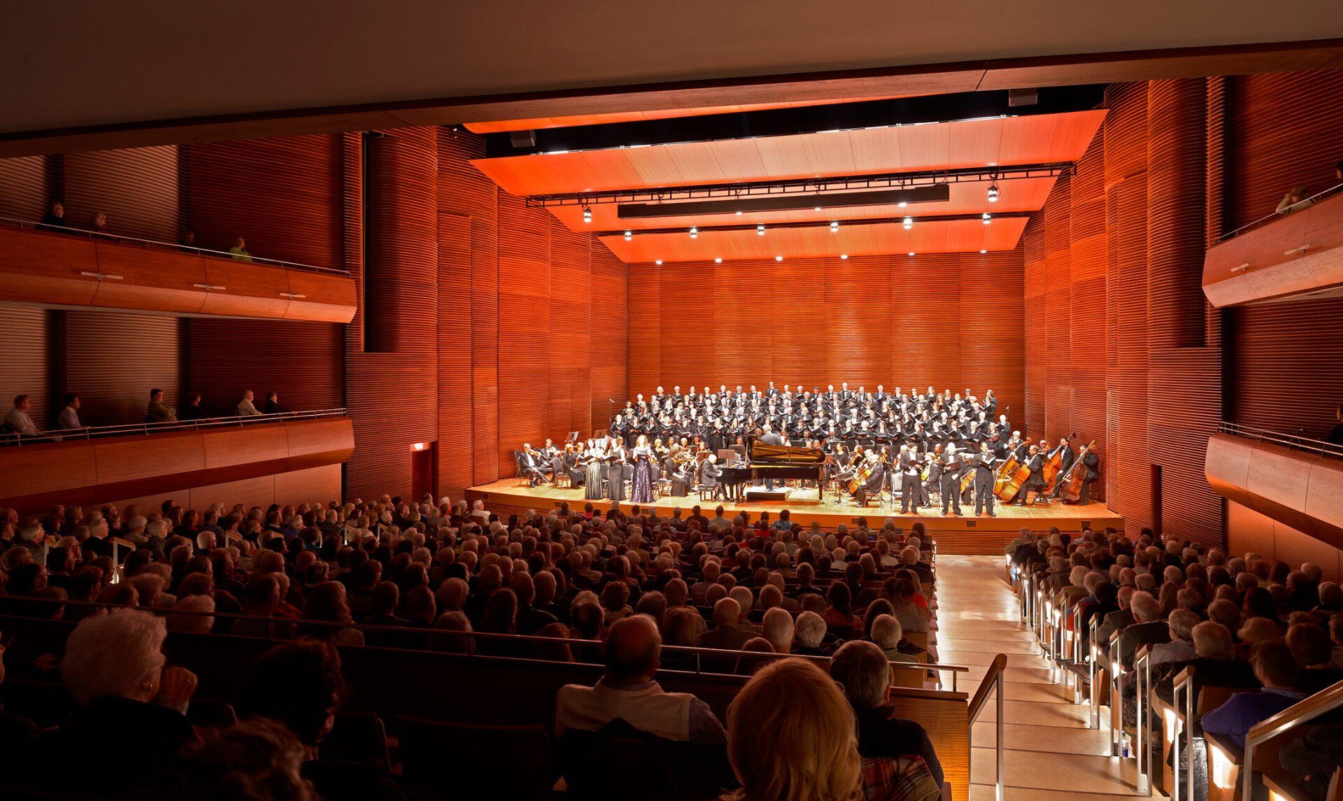 A large auditorium filled with people watching a concert
