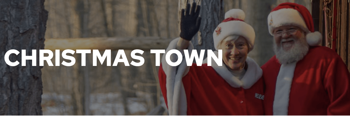 A man and a woman dressed as santa claus are standing next to each other