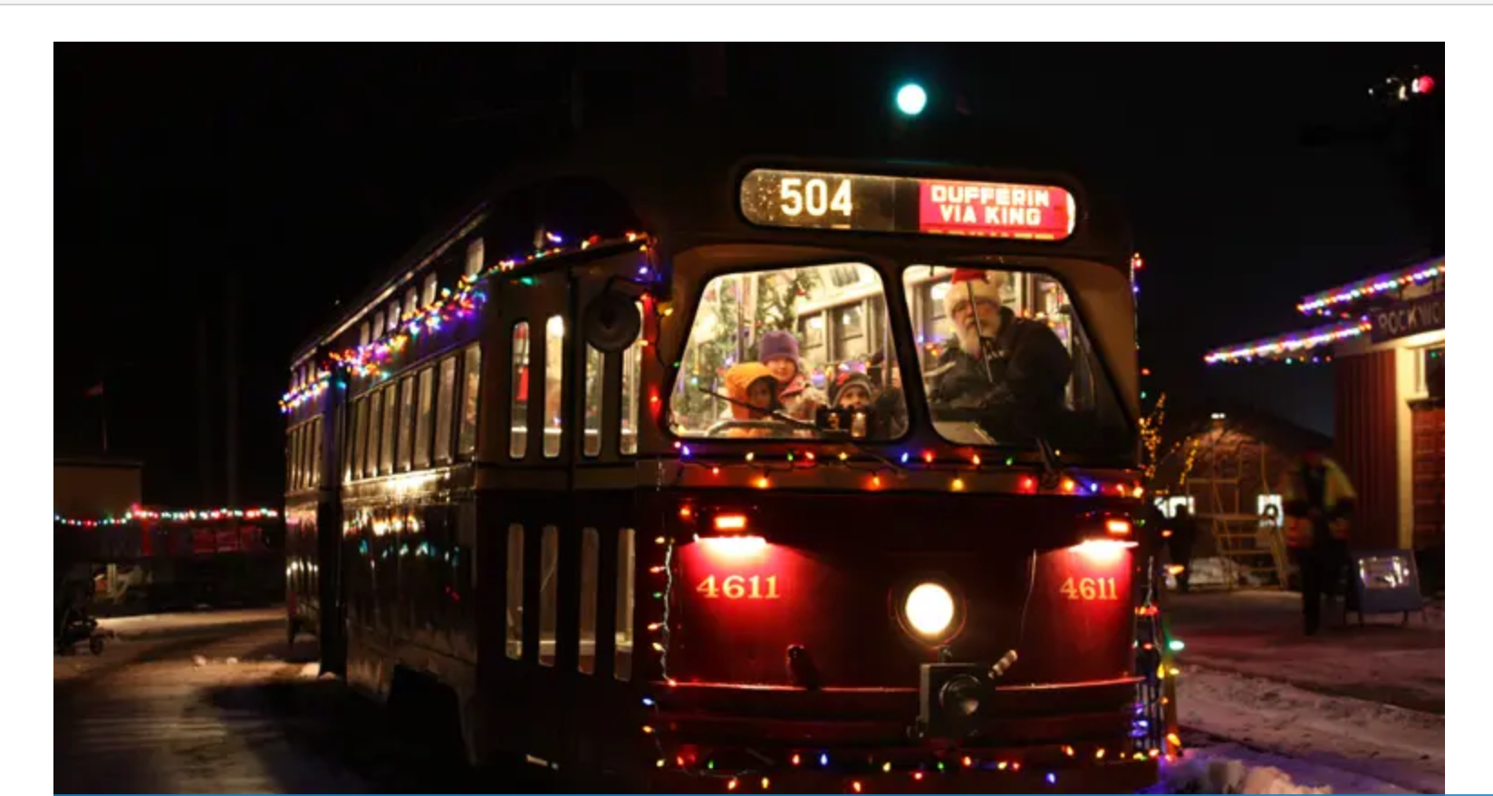 A bus is decorated with christmas lights and has the number 504 on the front