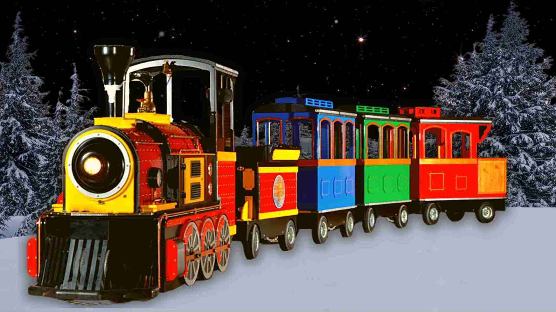 A colorful train is going through a snowy forest.