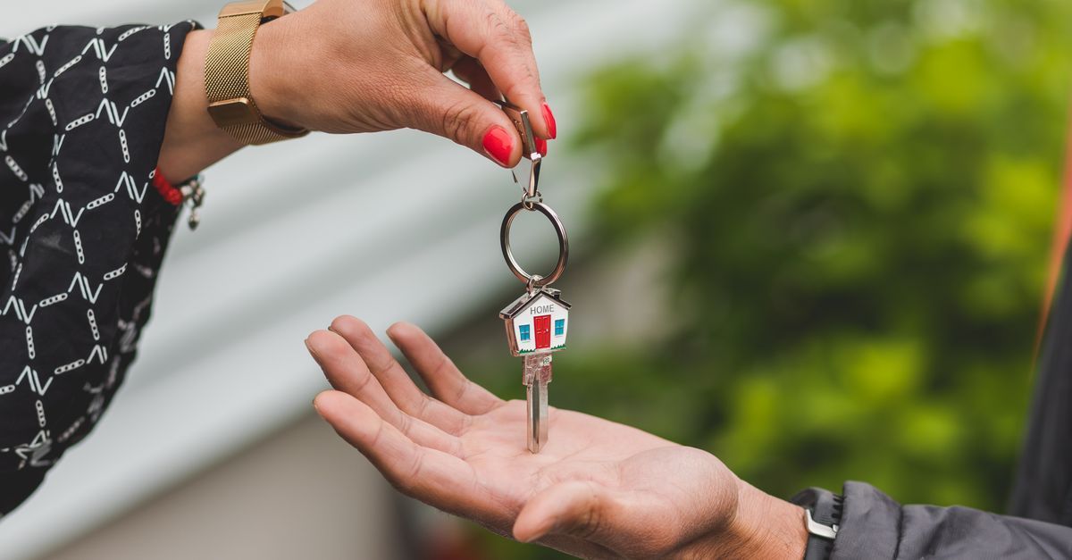 House keys being handed over outside a family home as one spouse buys out the other in Ontario