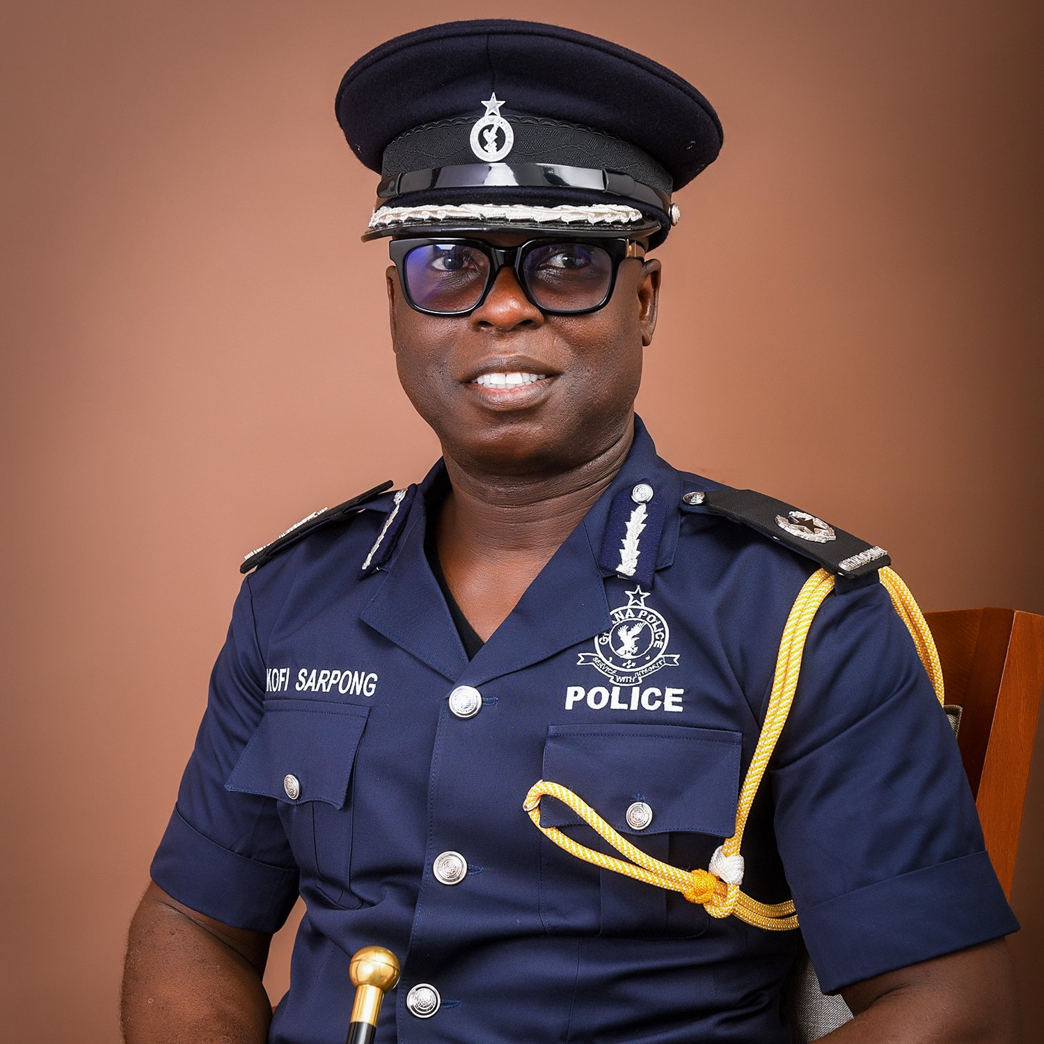 A man in a police uniform is sitting in a chair.