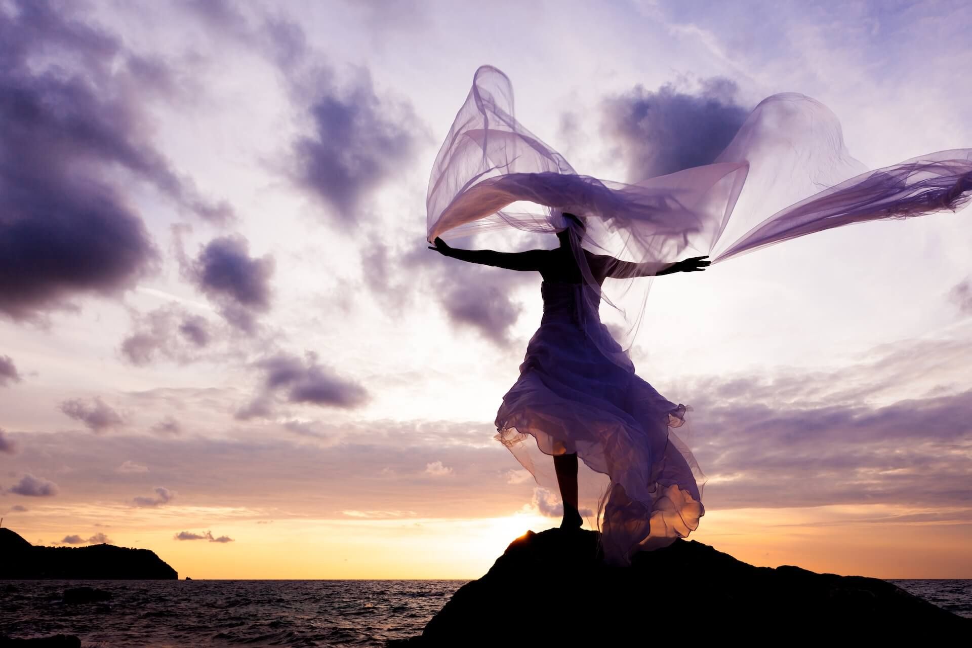 Women in sheer fabric looking into distance