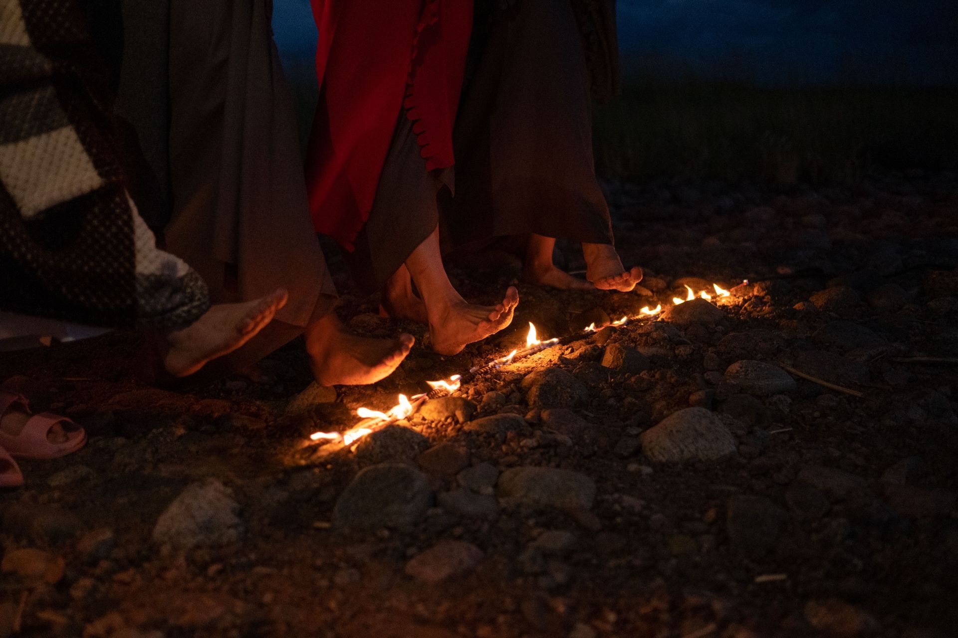 bare feet crossing a line of fire