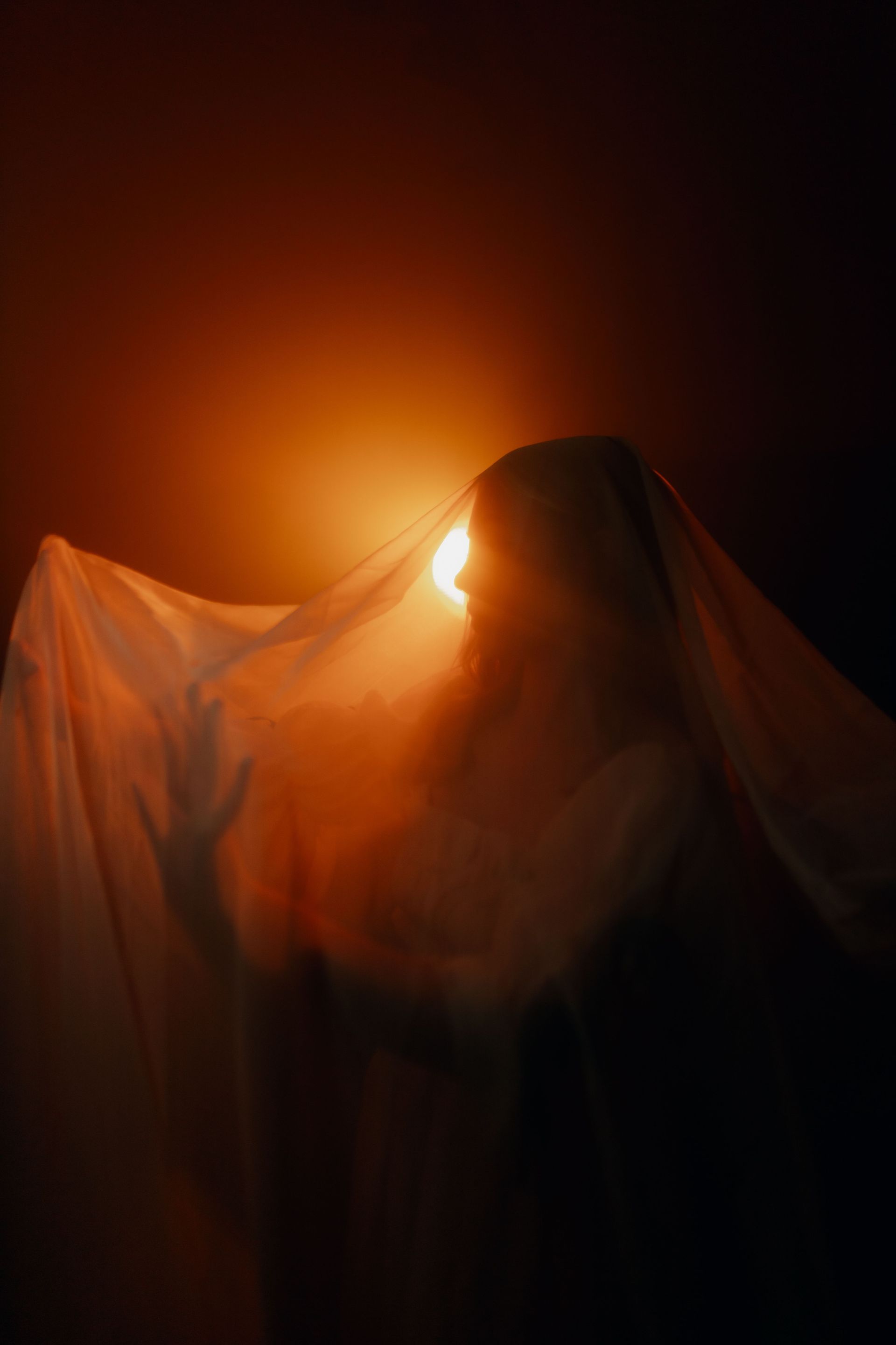 Women in sheer fabric looking into distance