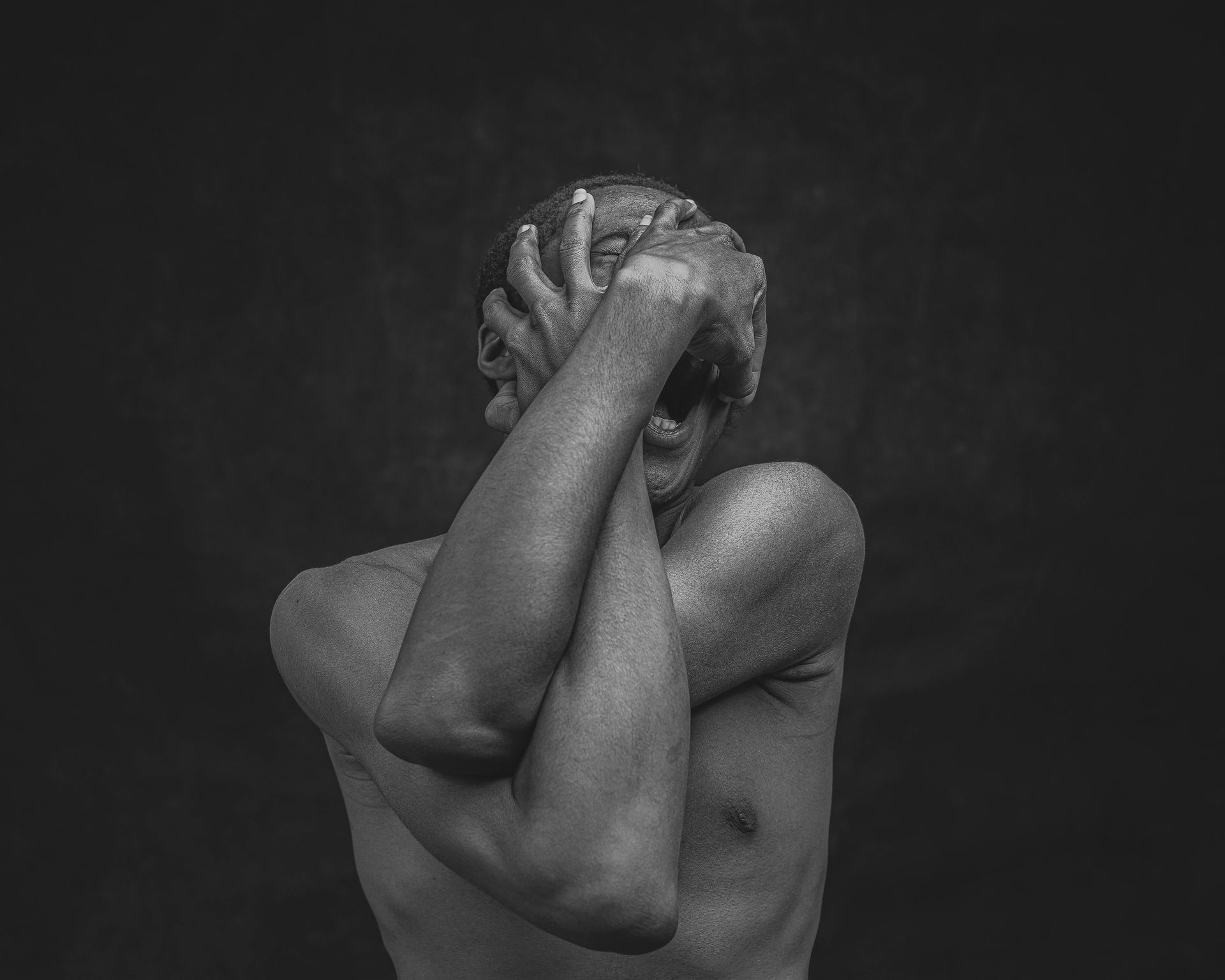 Human being going through an identity crisis, grabbing his face in frustration