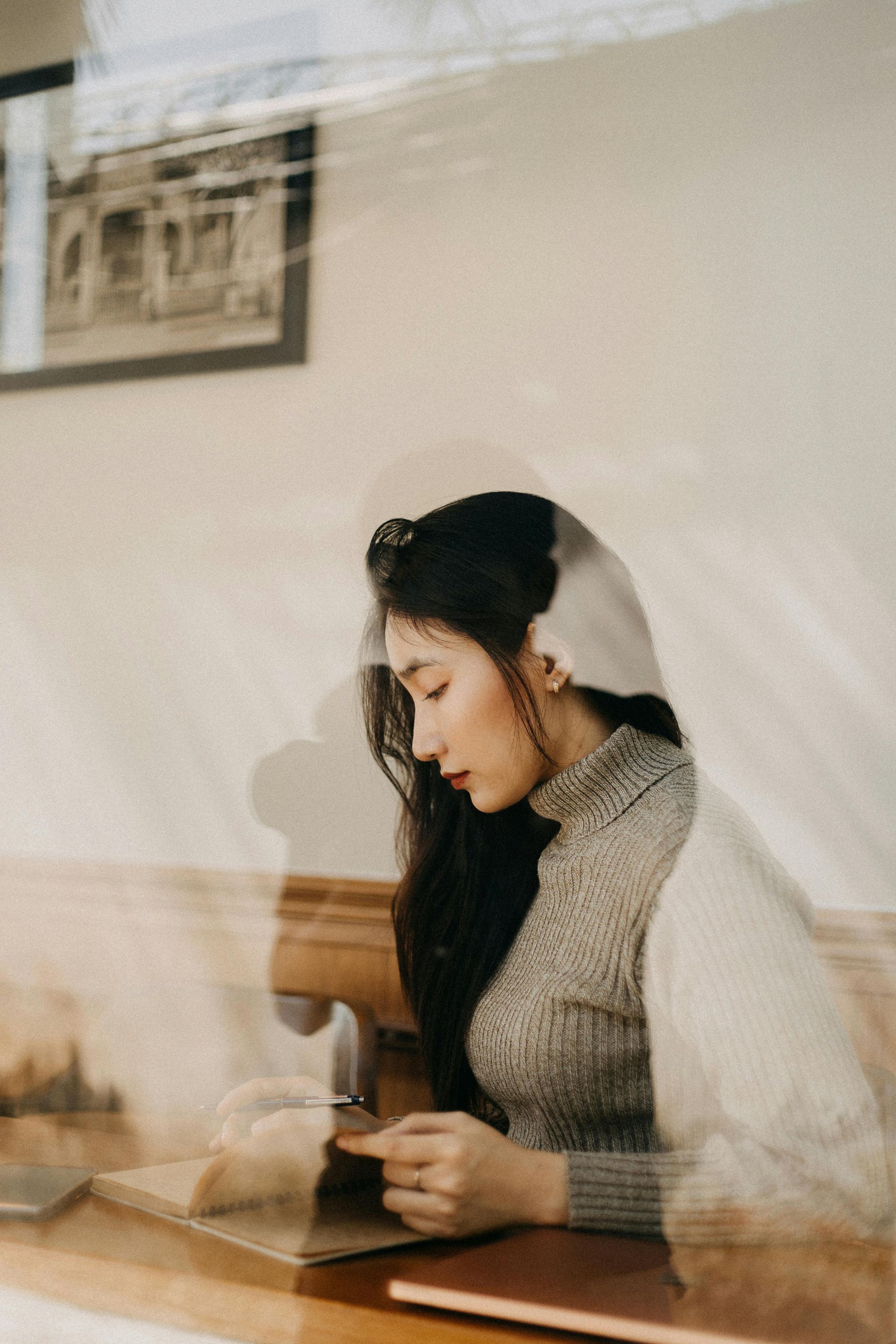 Woman looking down somber and reflective.
