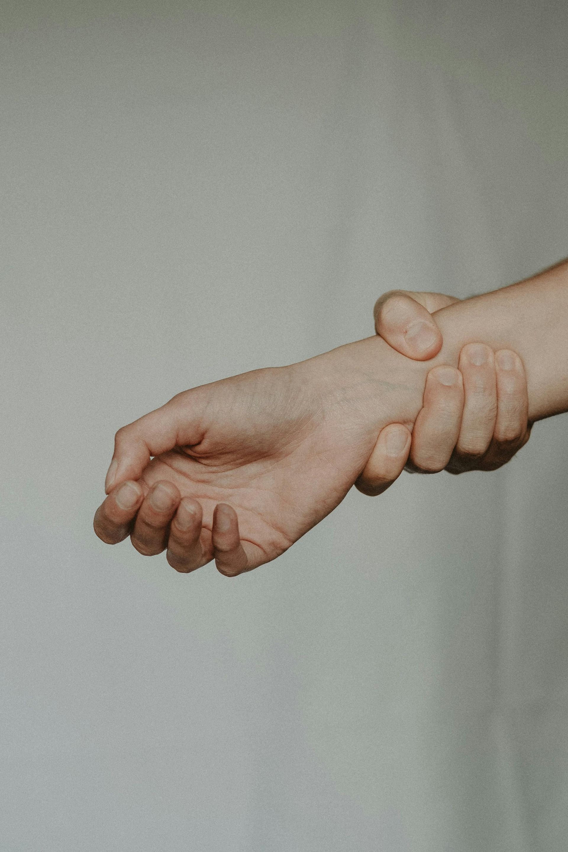Person touching wrists