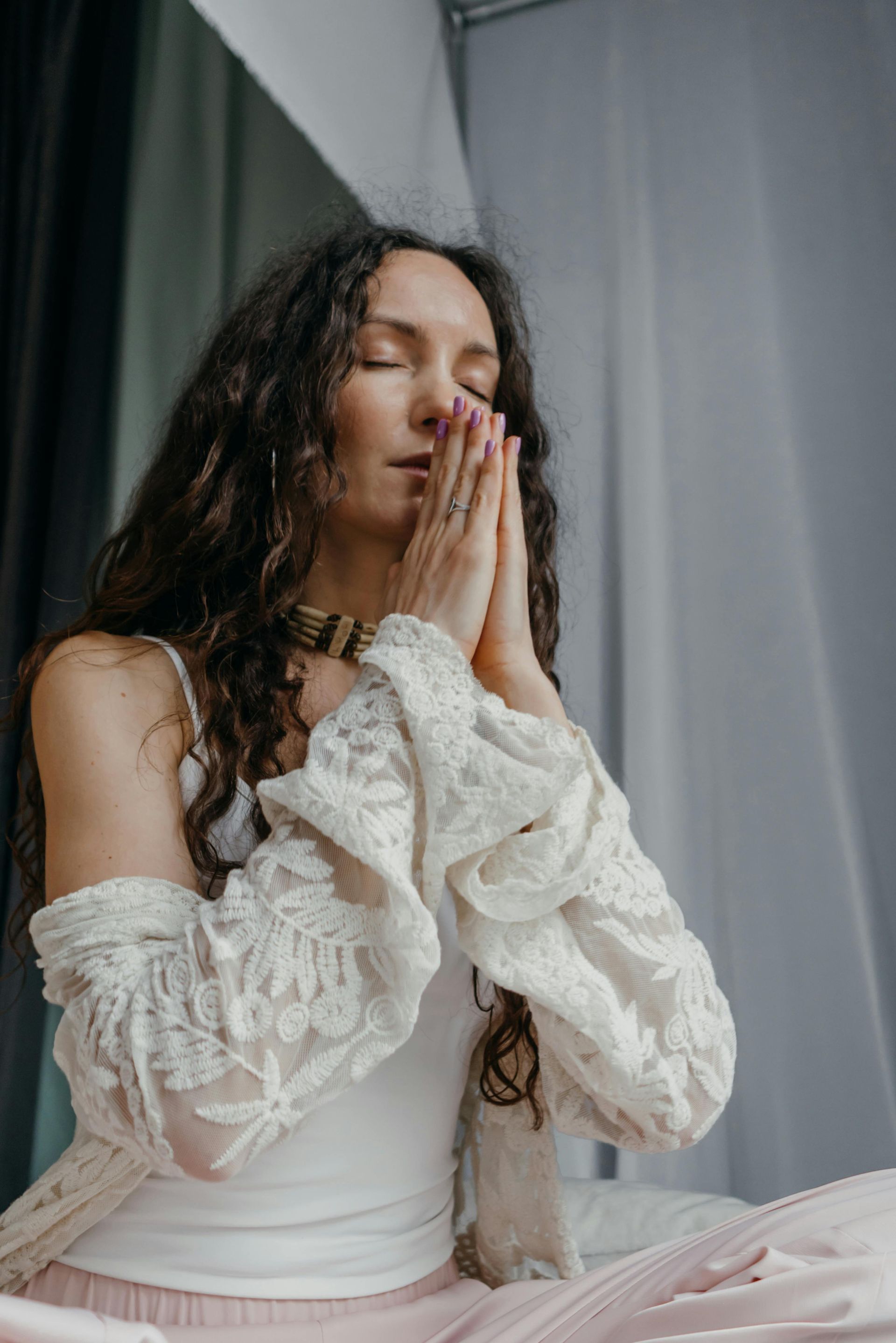 Woman in prayer with white dress and long har