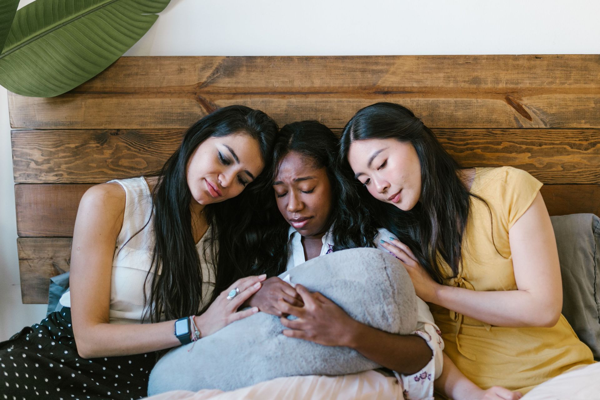 Women holding baby with support