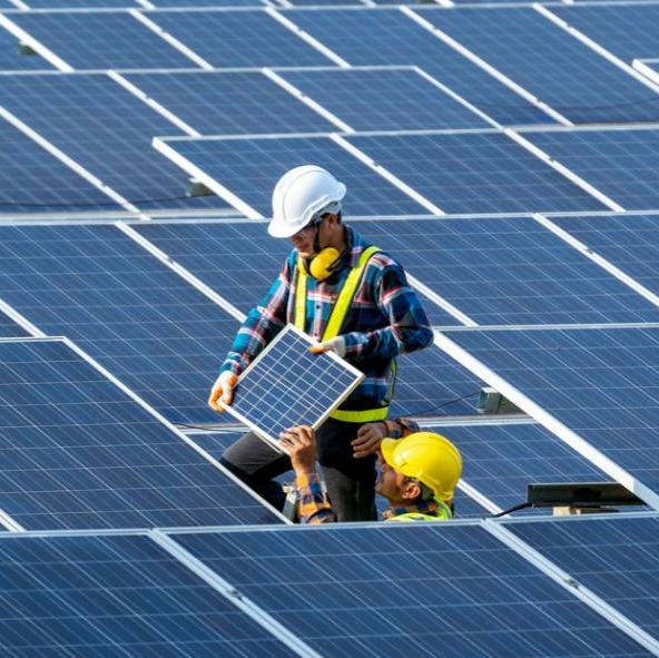 Worker installing solar panels