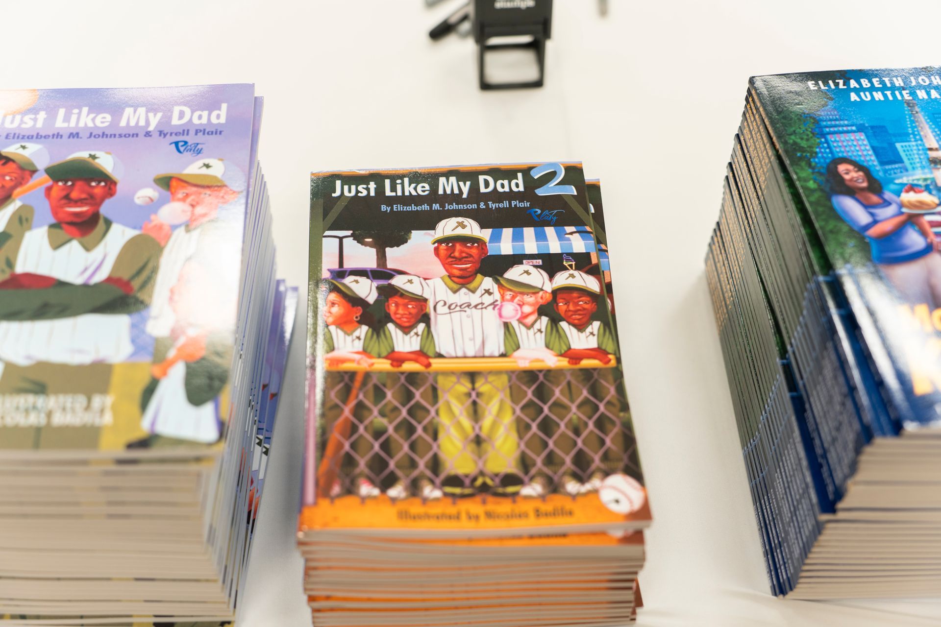 A stack of just like my dad books on a table
