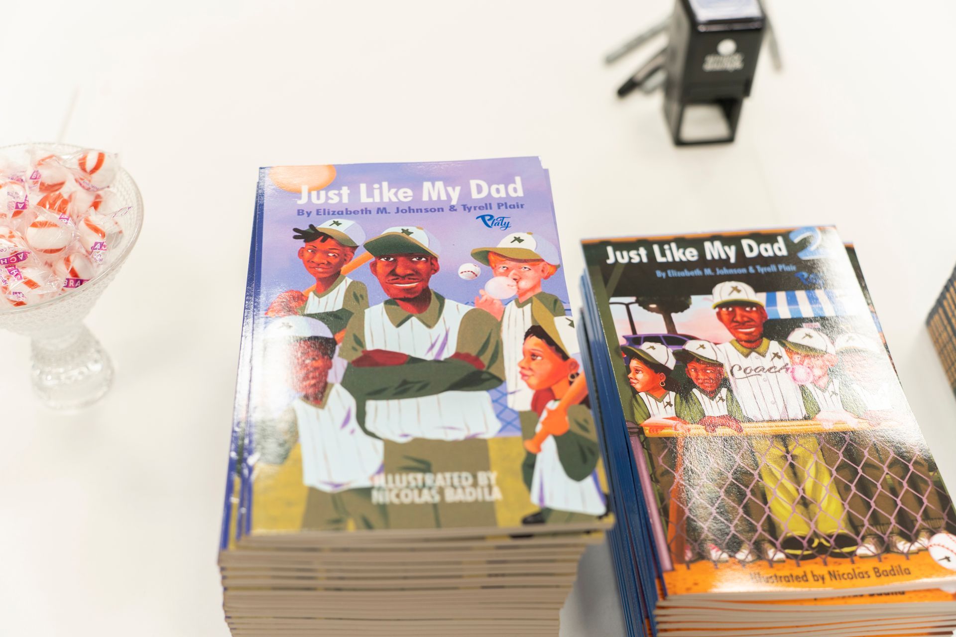 A stack of books titled just like my dad on a table.