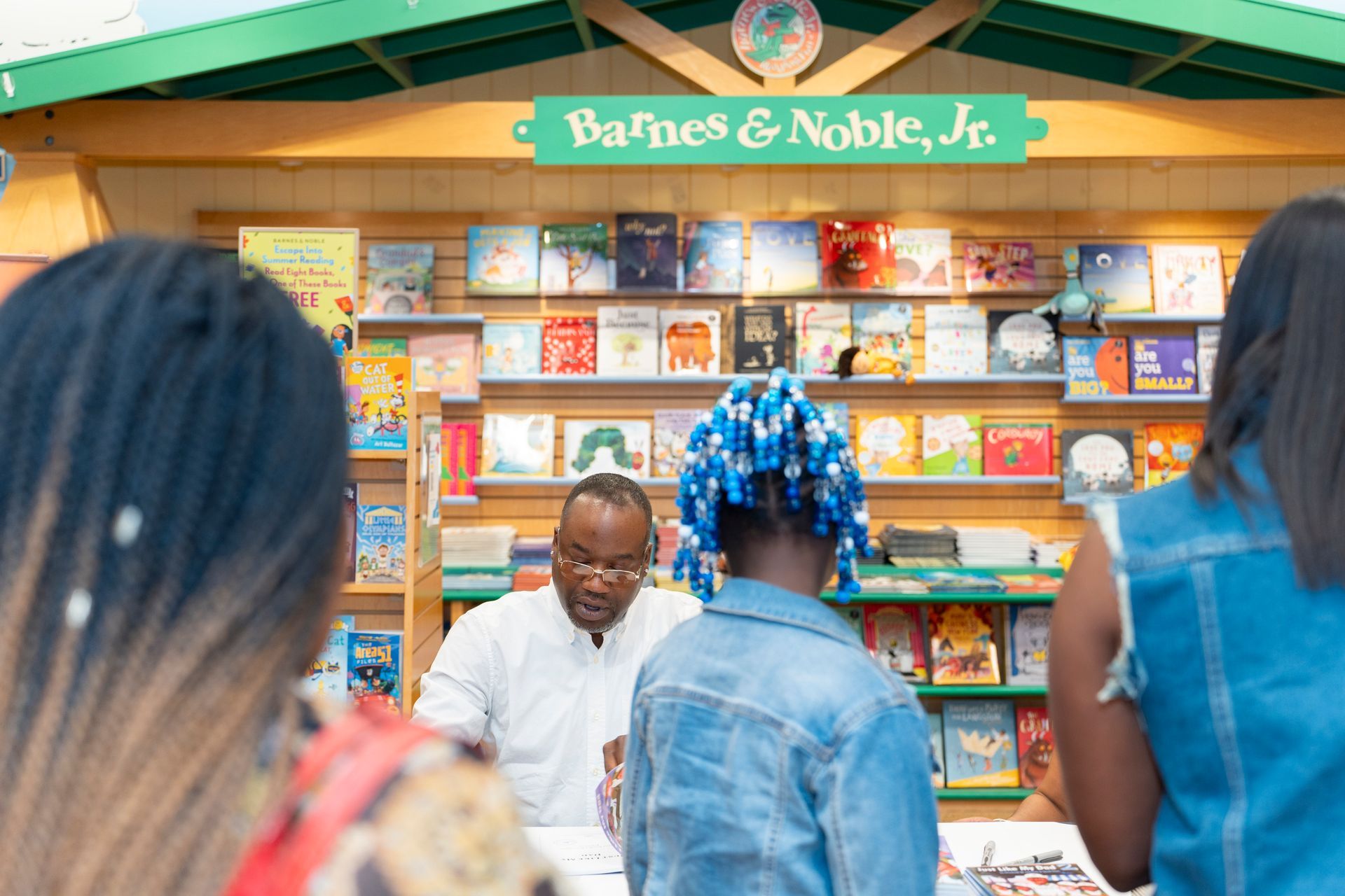 A group of people are standing in front of a book store.