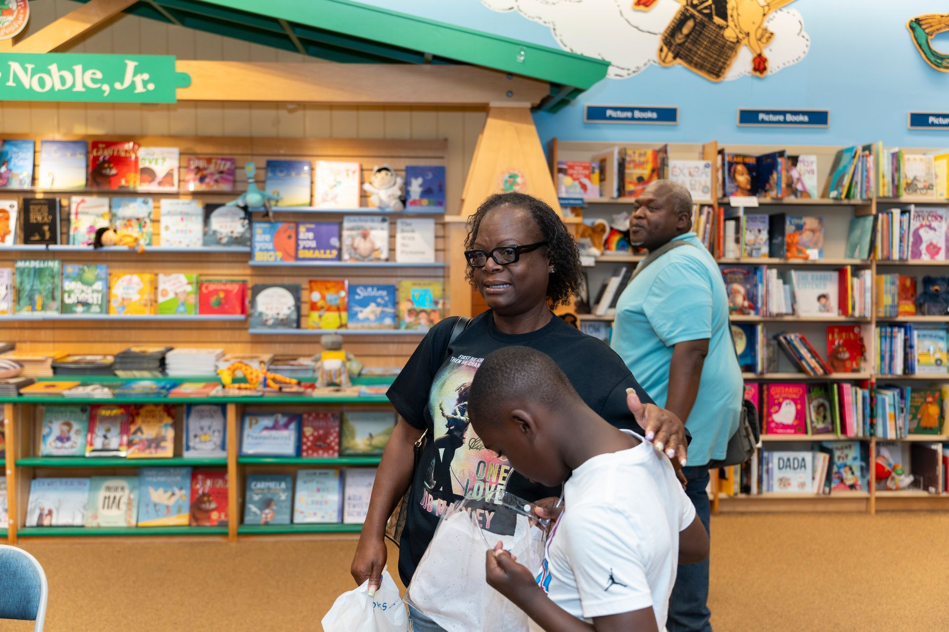 A group of people are standing in a bookstore.