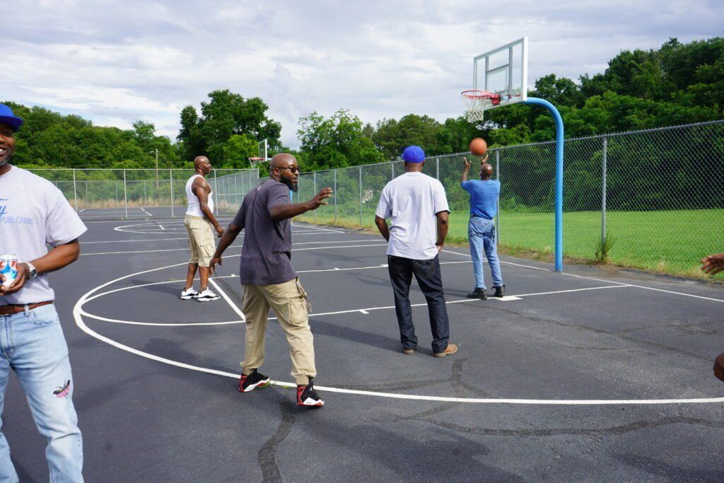 A group of men are playing basketball on a court