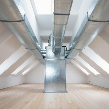 Attic room with exposed silver ductwork and skylights over a light wood floor