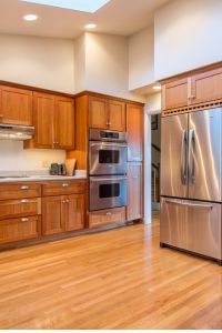 A kitchen with stainless steel appliances and wooden cabinets