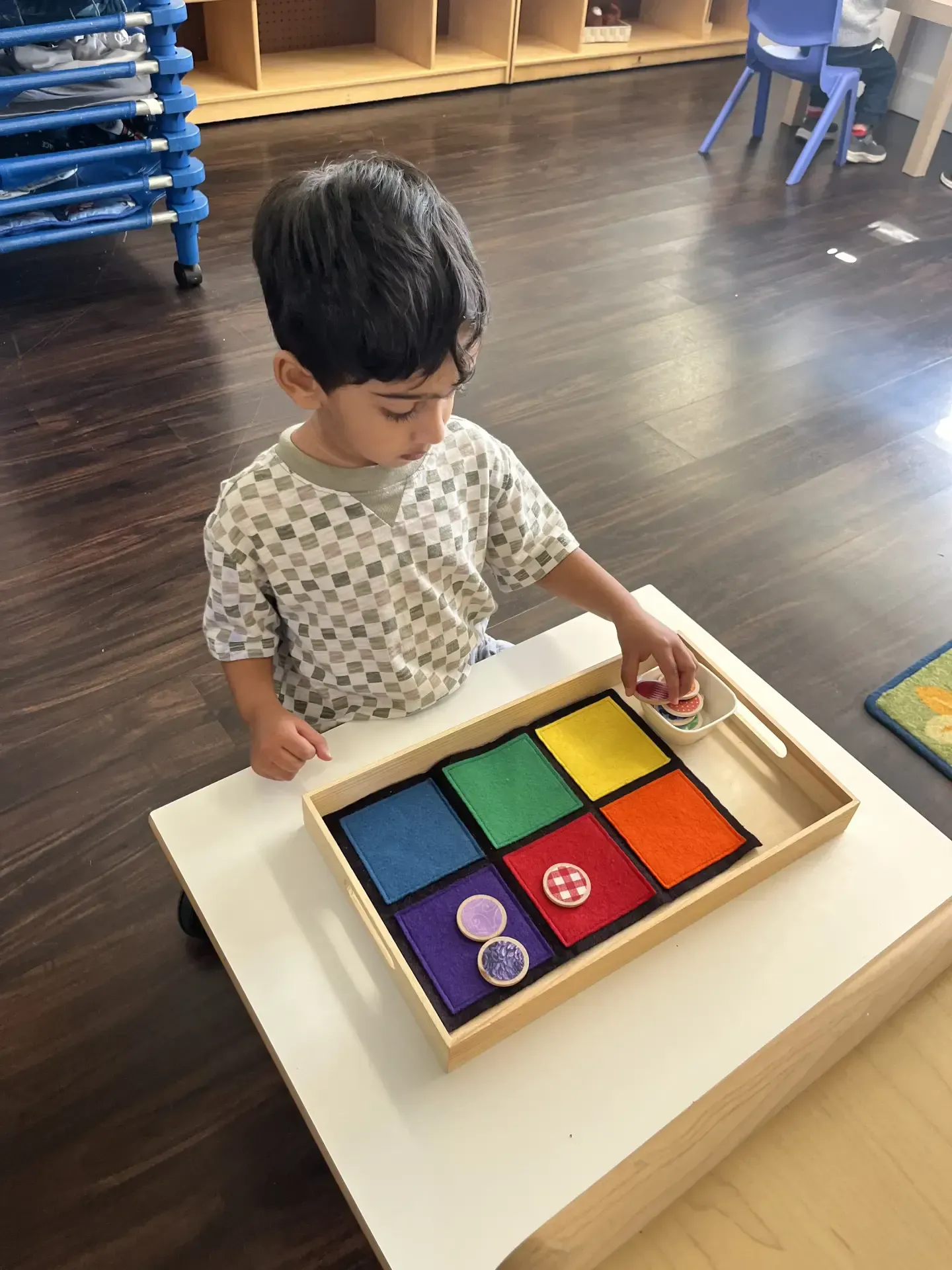 Montessori child working in the classroom with montessori materials