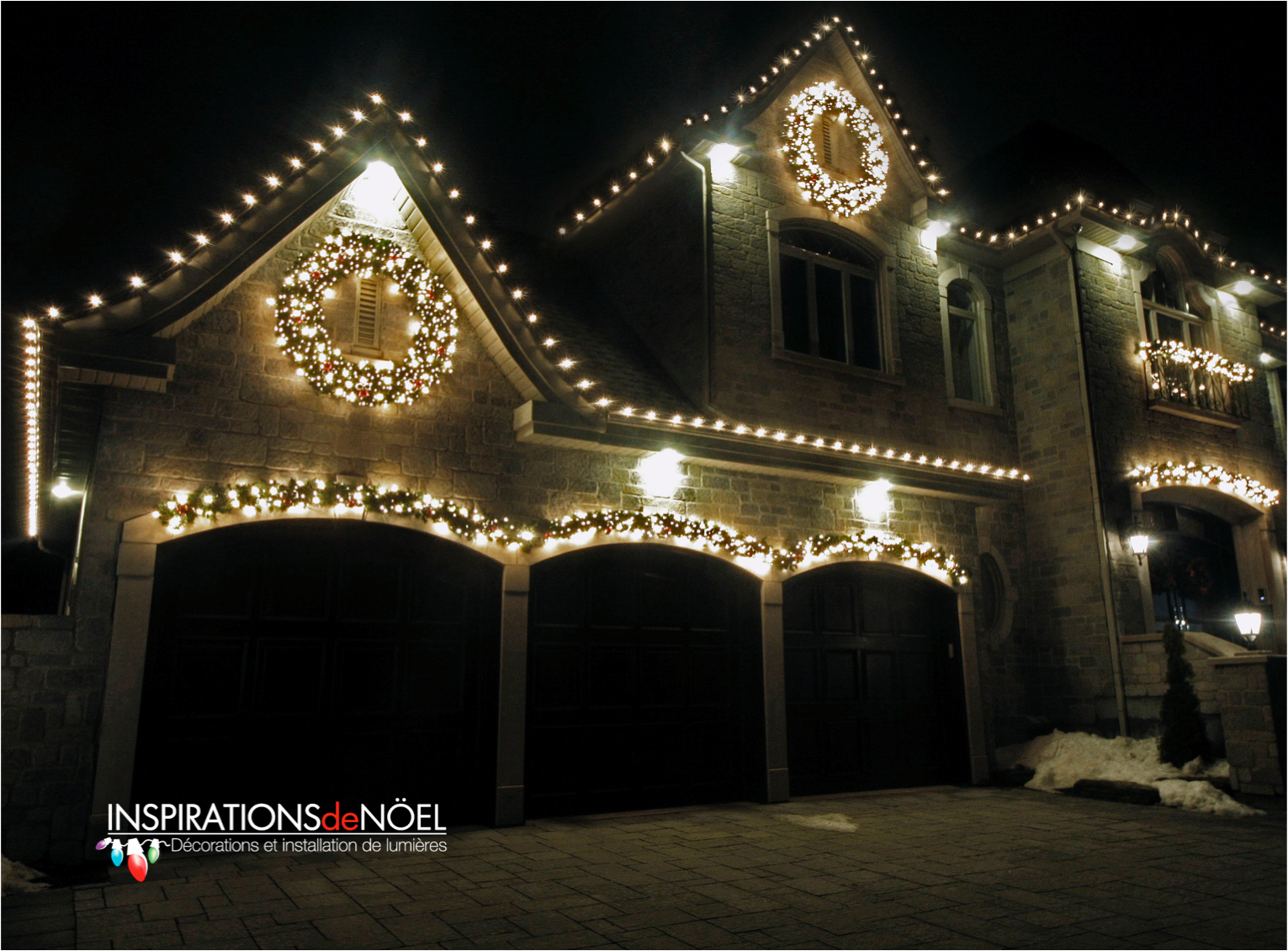A house is decorated with christmas lights and a wreath