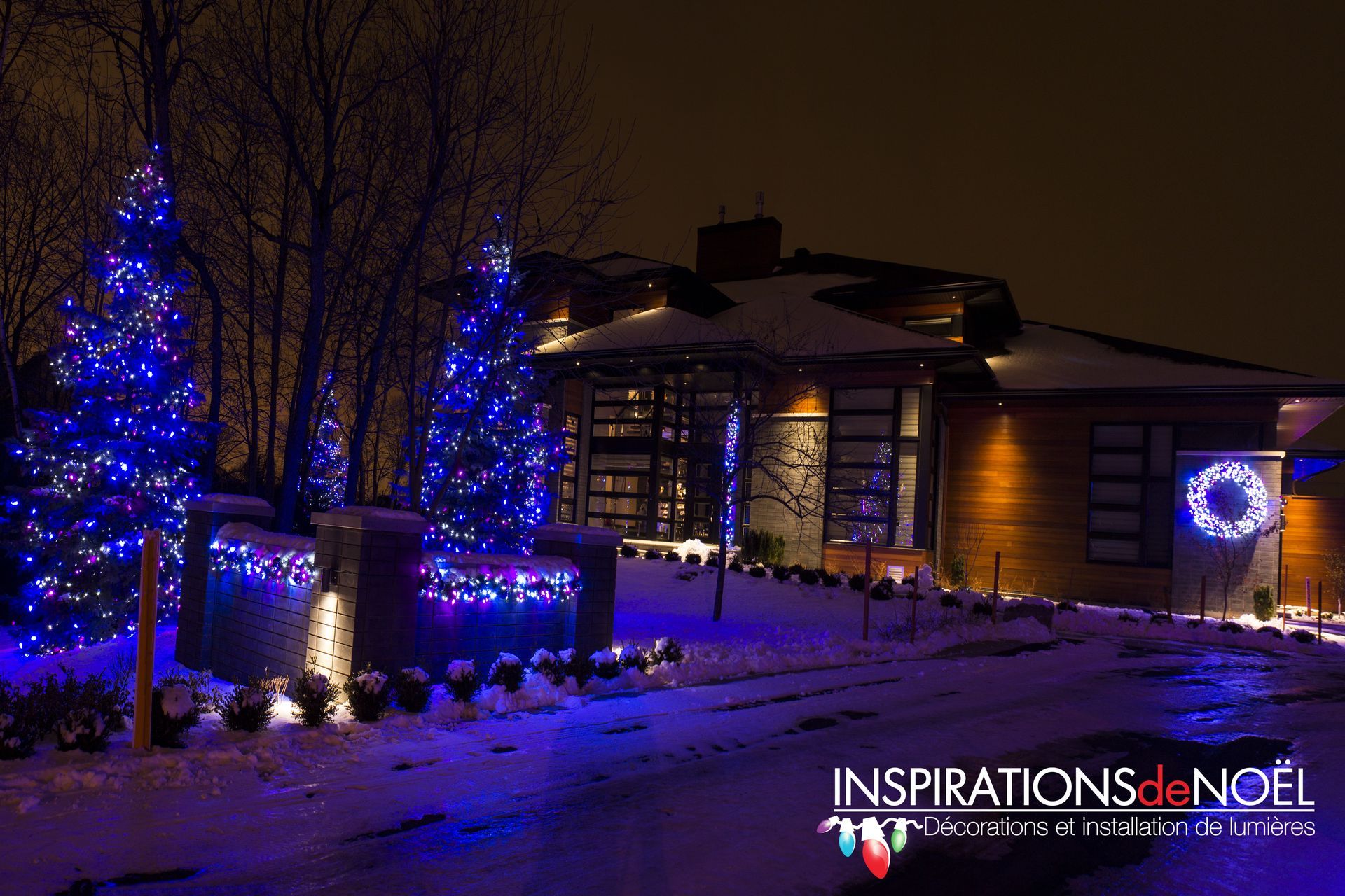 A house is decorated for christmas with blue lights