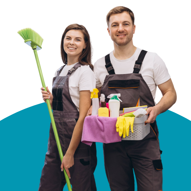 Two cleaners in aprons, one holding a broom and one carrying a cleaning caddy with supplies.