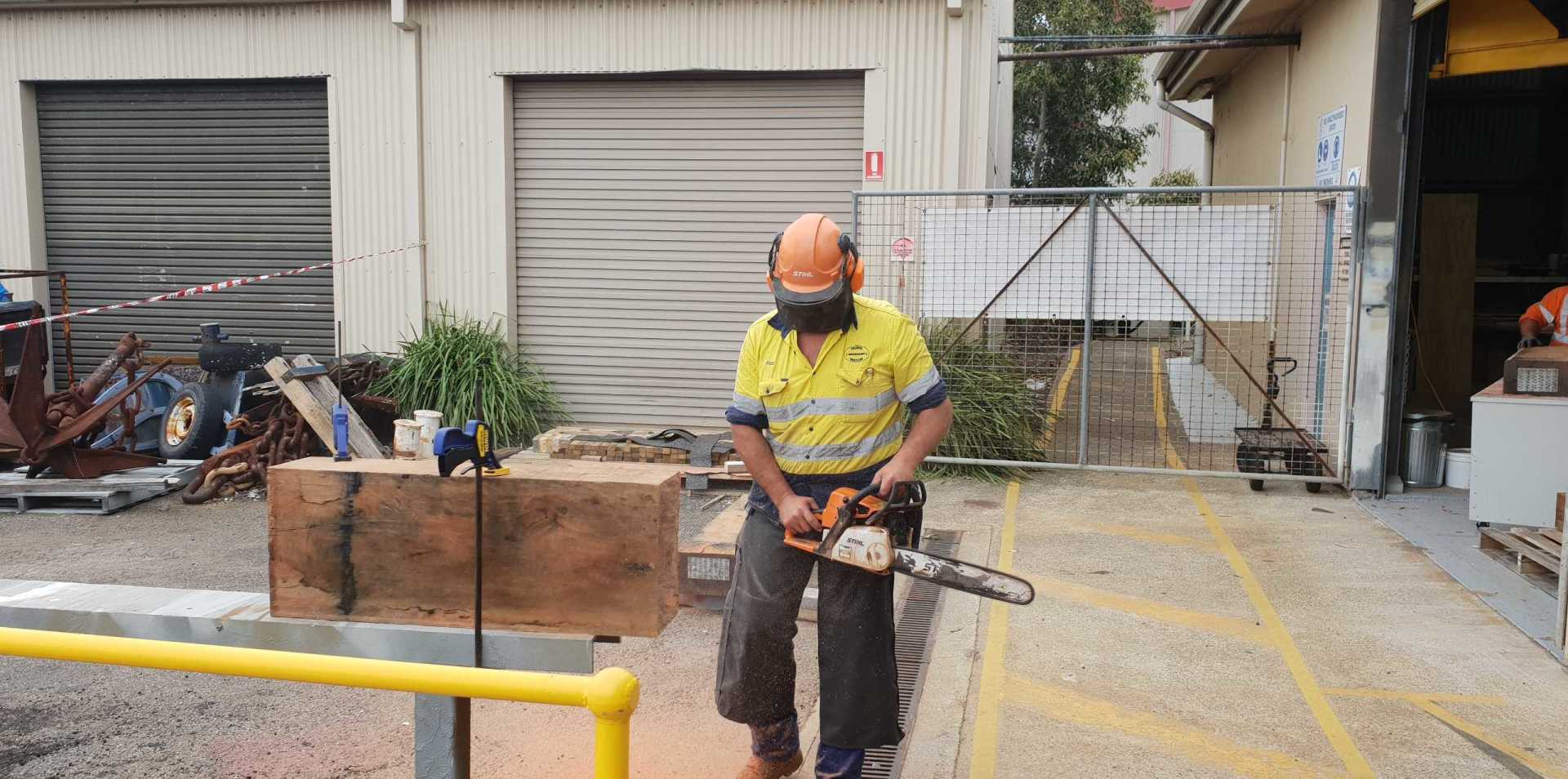Worker Holding a Chainsaw — Newcastle, NSW — Channel Shipwright Services