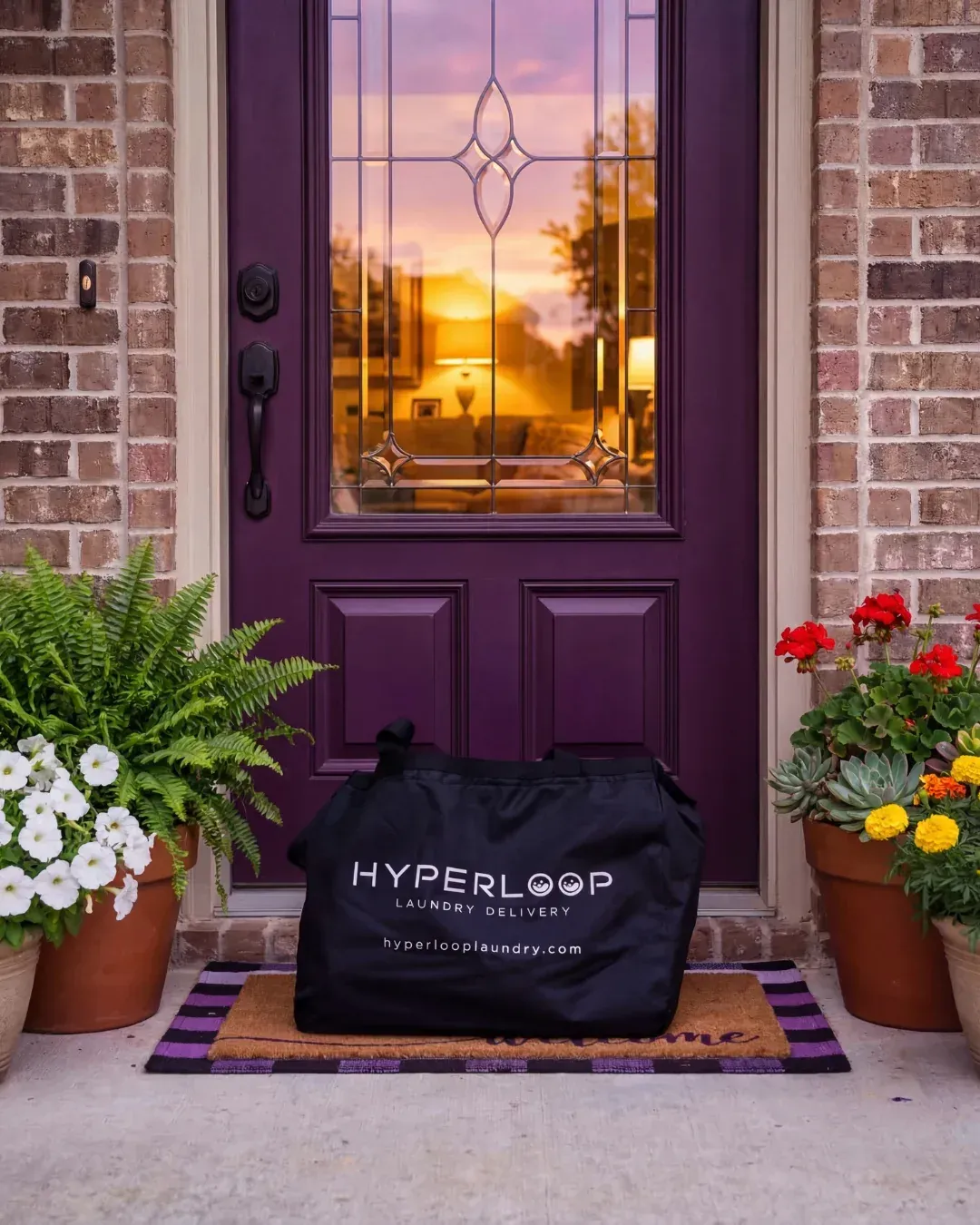 Freshly folded laundry in a Hyperloop bag waiting on a customer's doorstep