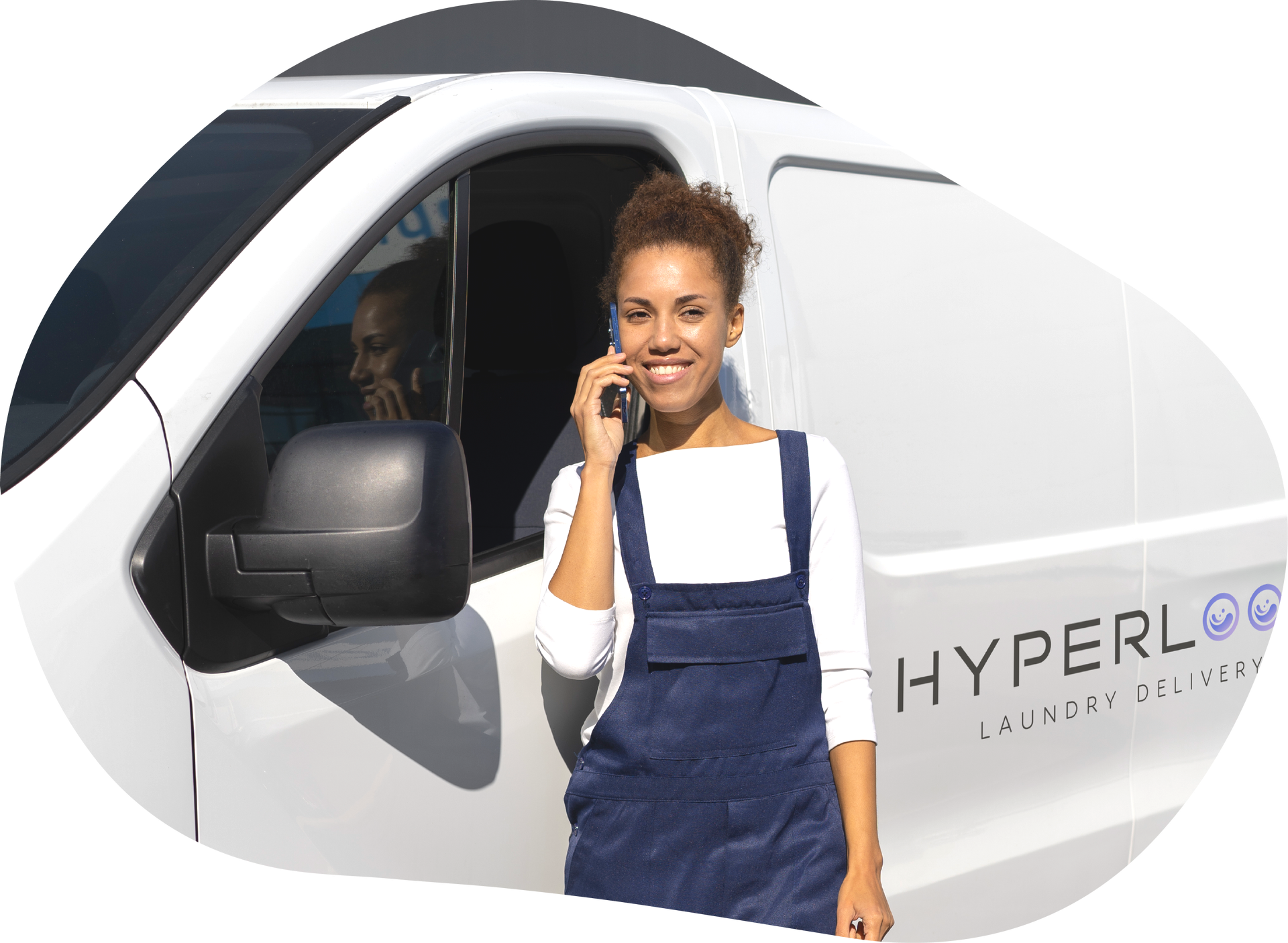 Woman leaning against a white van, talking on a phone, smiling. Van has