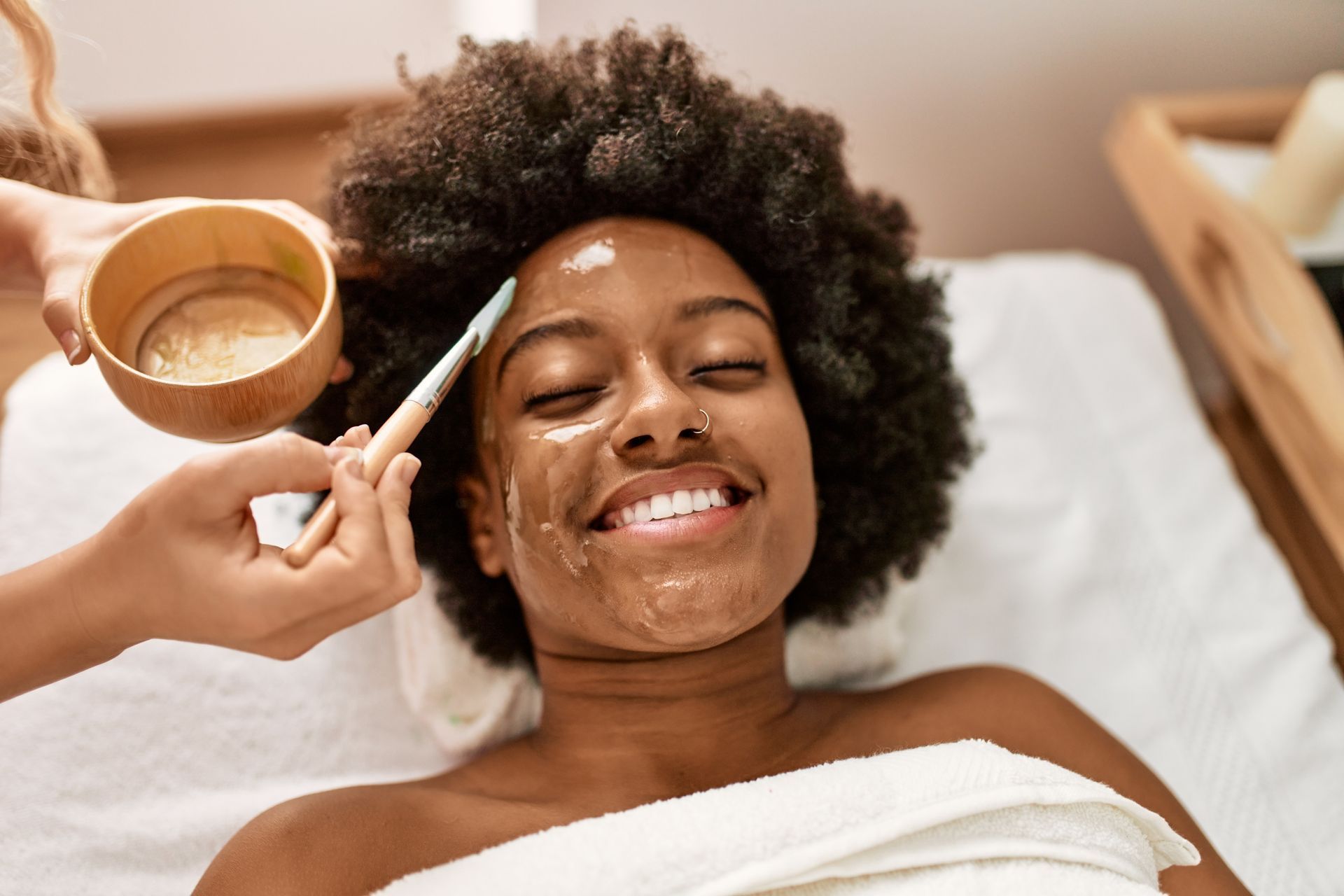 A woman is getting a facial treatment at a spa.