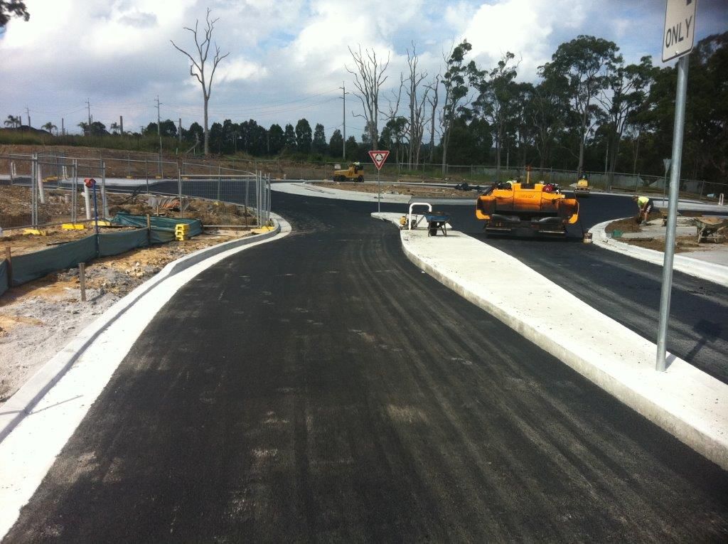 Newly Repair Asphalt Road with a Machine on the Side — Sydney, Nsw — C & C Asphalt Pty Ltd